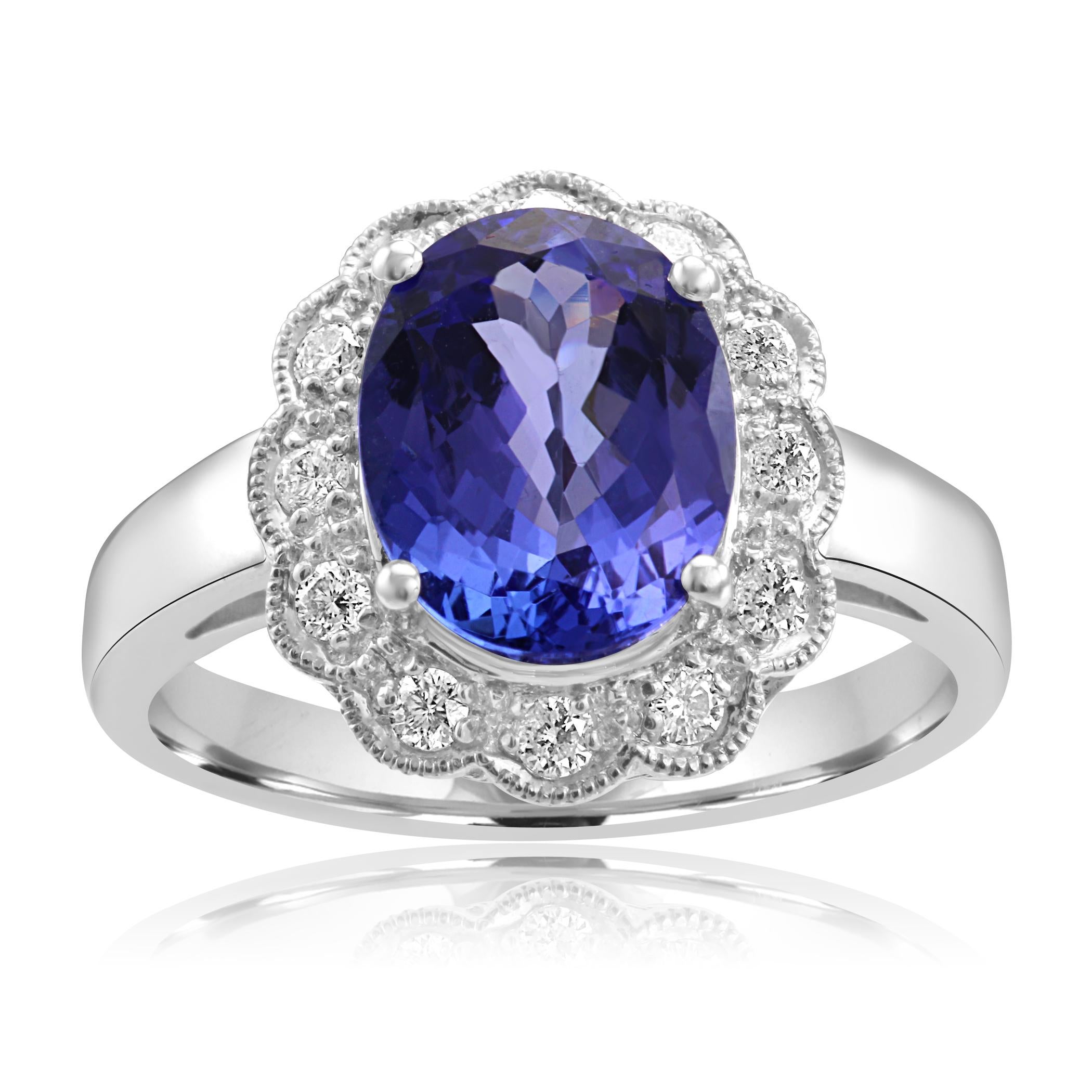 Desirable Tanzanite Oval 2.79 Carat encircled in a single Halo of White G-H Color SI Diamond Rounds 0.25 Carat in 14K White Gold Bridal Cocktail Ring with filigree work.

Total Stone Weight 3.04

Style available in different price ranges, can be