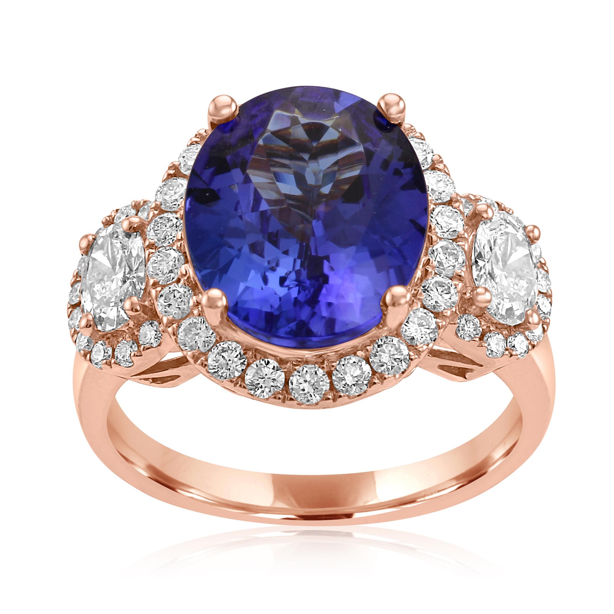 Stunning Tanzanite Oval 4.81 Carat Flanked by 2 White G-H color VS-SI Clarity Diamond Ovals 0.80 Carat encircled in single Halo of White G--H Color SI clarity Diamond Rounds 0.60 Carat set in Gorgeous 18K Rose Gold Three Stone Fashion Cocktail