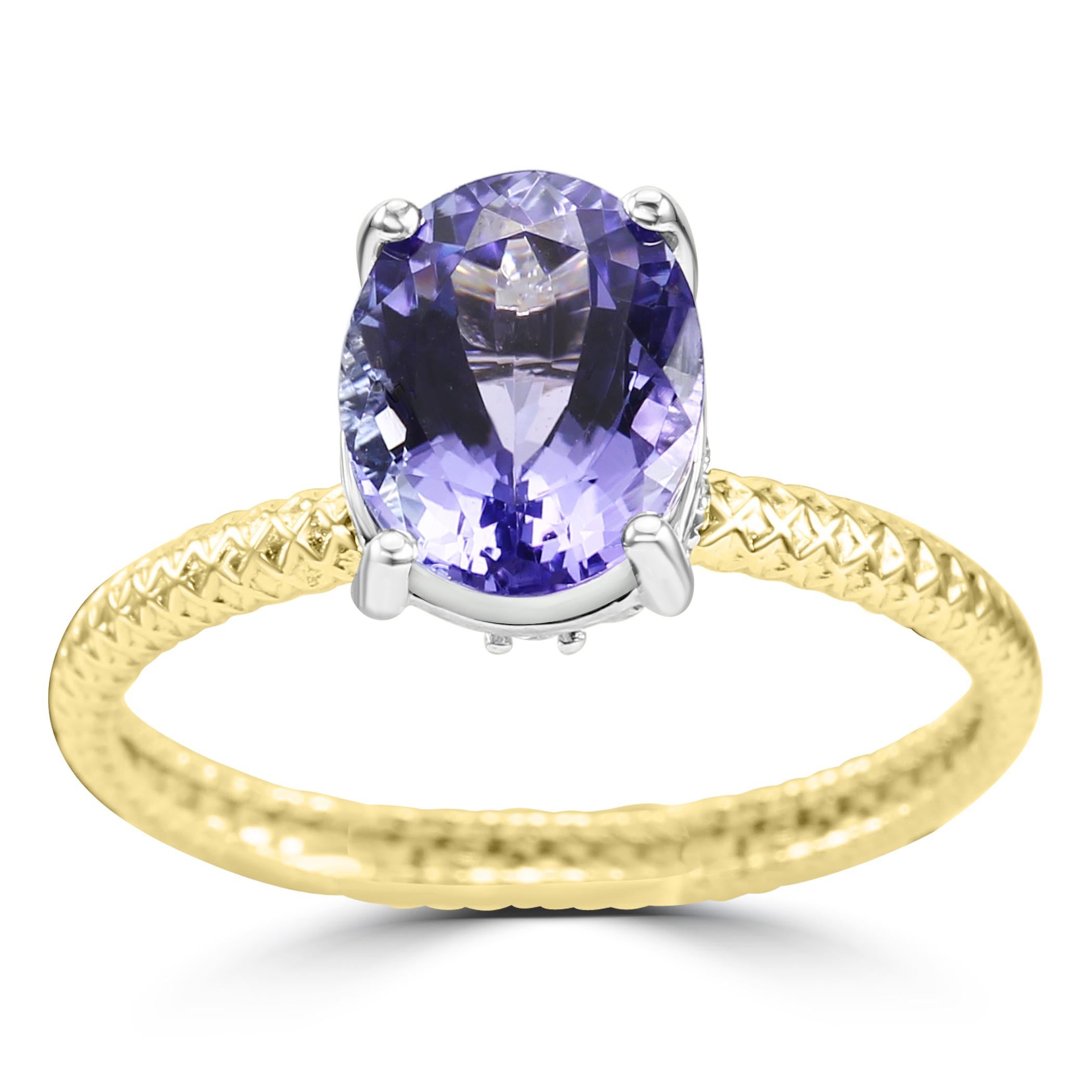 The heart and soul of this ring is the beautiful Tanzanite Oval, boasting a generous 2.33 carats, capturing the mesmerizing hues of violet-blue that are characteristic of this rare gemstone.

Adding a touch of elegance to the design, the ring