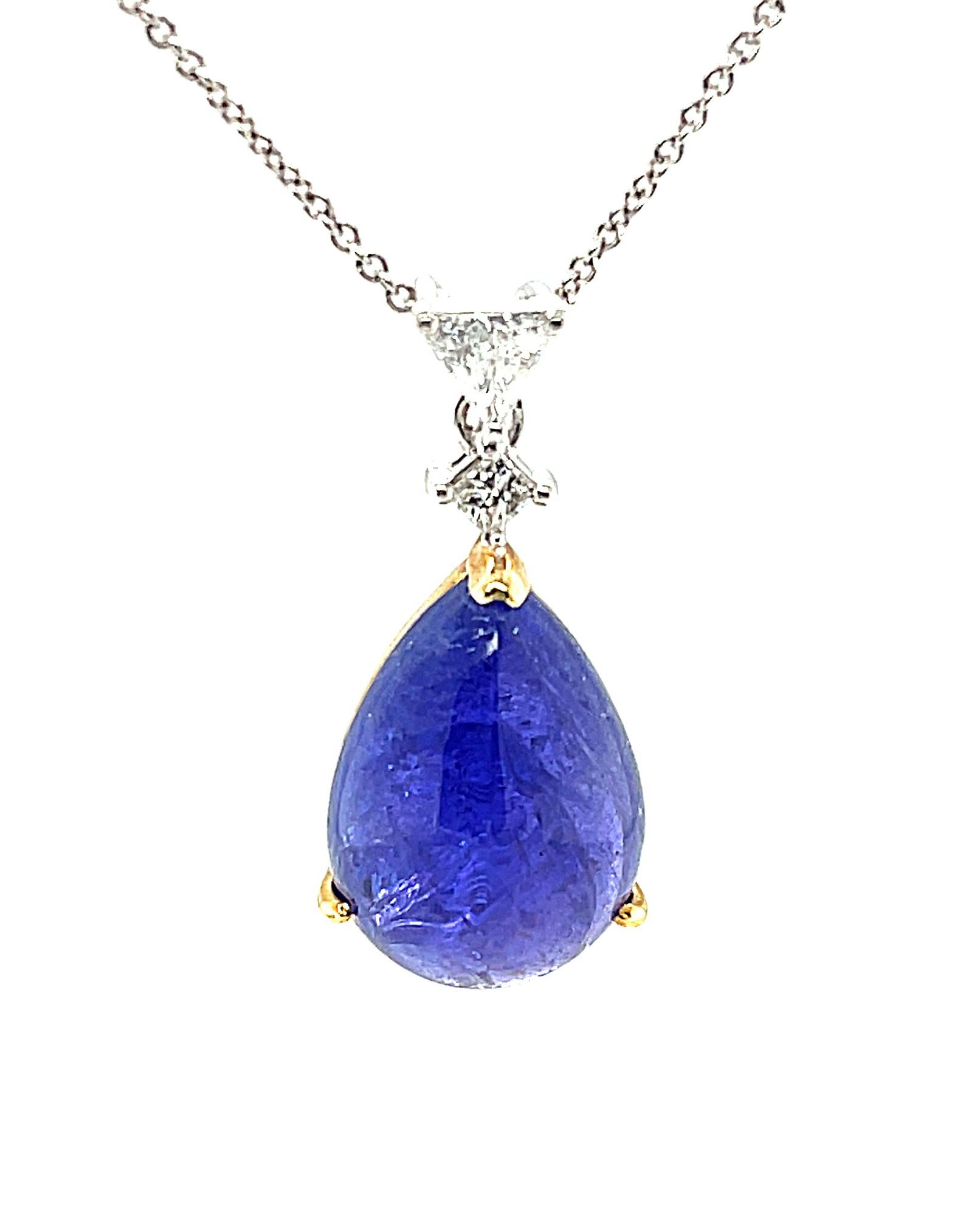 This pendant features a beautiful 12.56 carat tanzanite cabochon with the rich, lavendar-blue color that tanzanite is famous for! This gorgeous jewel hangs suspended from sparkling trillion and princess cut diamonds for a unique, yet timeless look.