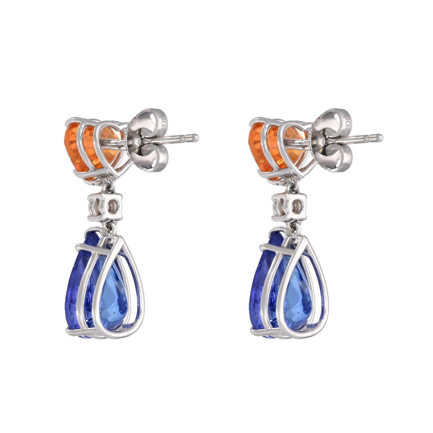 Marvelous pair of Tanzanite pear shapes weighing a total of 7.03 carats are suspended from a pair of heat shaped Mandarin Garnets weighing a total of 3.89 carats, and marquise shaped diamonds weighing a total of 0.19 carats, creating this rich and