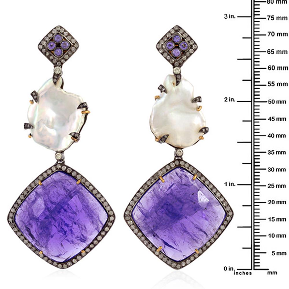 Three tier sliced Tanzanite Pearl Diamond Earring in silver and gold is a pretty earring for a wedding to cocktails to any occasion.

Closure: Push Post

18kt: 3.308gms
Diamond: 2.31ct
Silver: 11.04gms
Tanzanite: 74.40ct
Pearl: 19.90ct