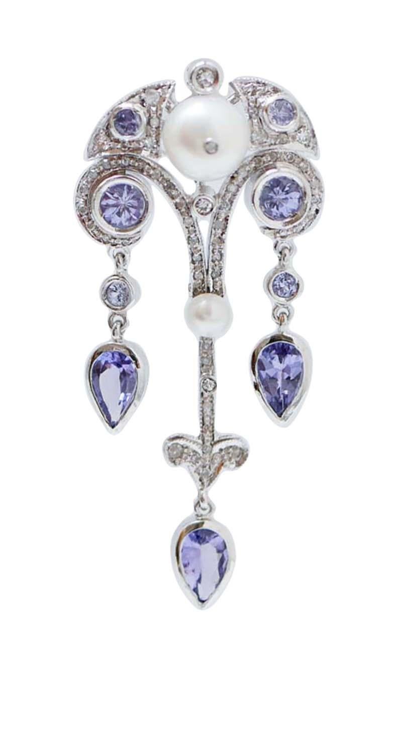 Fantastic earrings in platinum structure mounted with with a pearl and a diamond in the upper part surrounded by diamonds and tanzanite. As pendants, drop tanzanite and diamonds.
These earrings were totally handmade by Italian master goldsmiths and