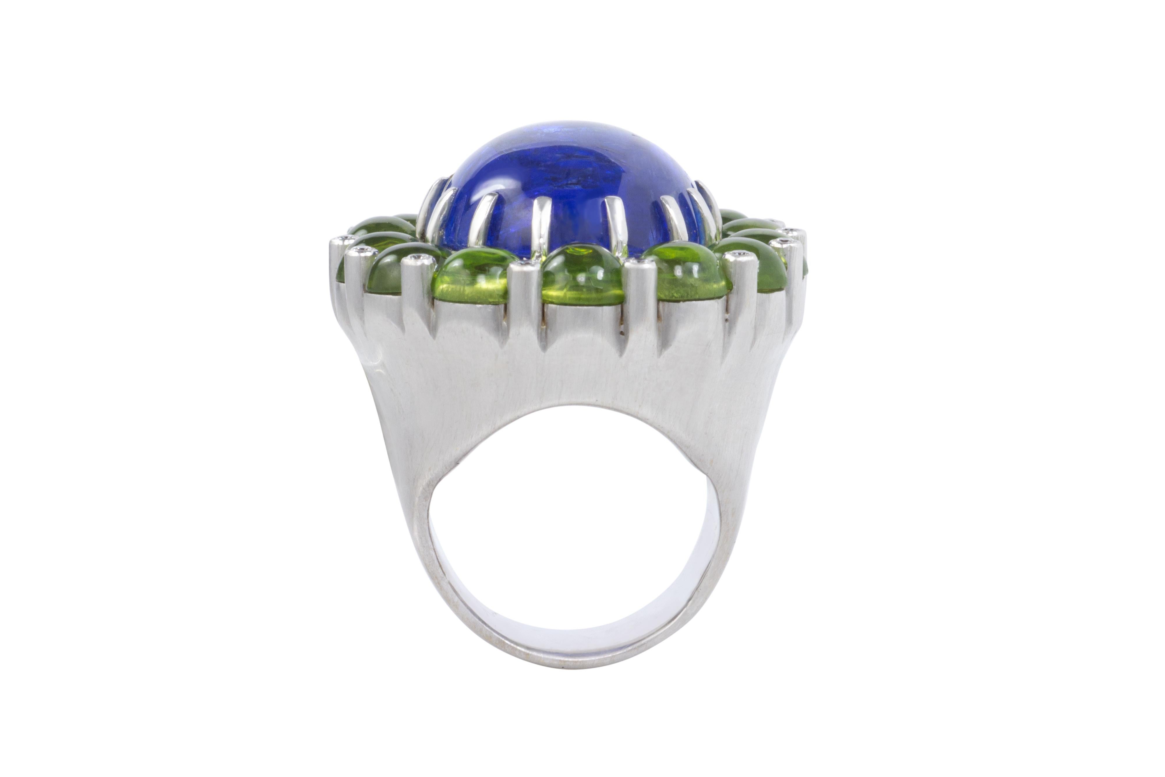 A tanzanite, peridot, diamond and 14 karat white gold ring. The ring is a size 5.5 and measures 1.5