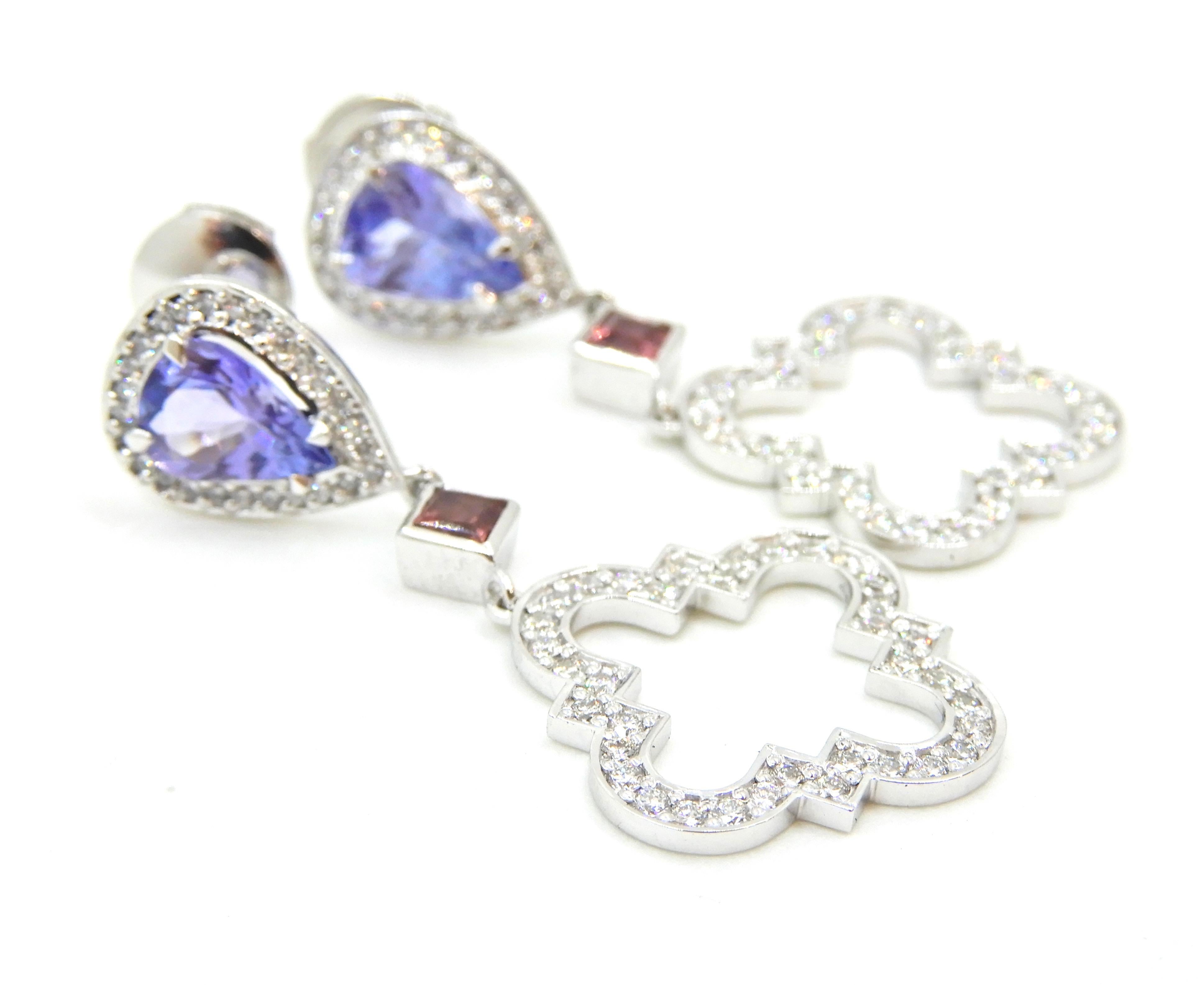 These stunning Tanzanite Pink Sapphire Diamond and 18 Carat White Gold Earrings will capture your imagination and heart.
Part of the Du Maroc collection, these earrings feature a stud comprising a claw set diamond halo around central 4 claw set pear
