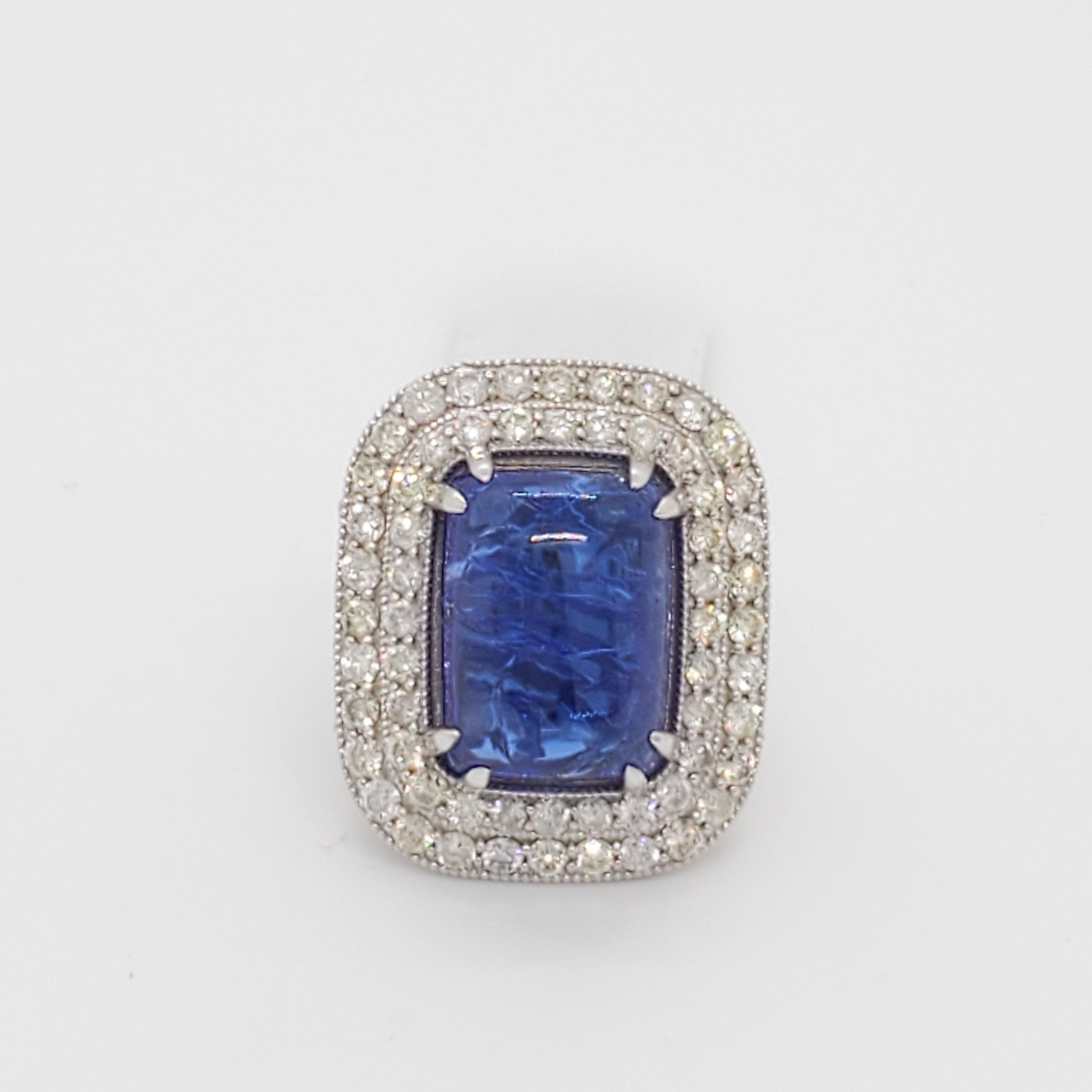 Gorgeous big size tanzanite rectangular cabochon with good quality white diamond rounds.  Handmade in 18k white gold.  This ring was bought in a large lot so accurate weights are unknown but close approximation can be given in message.  Ring size