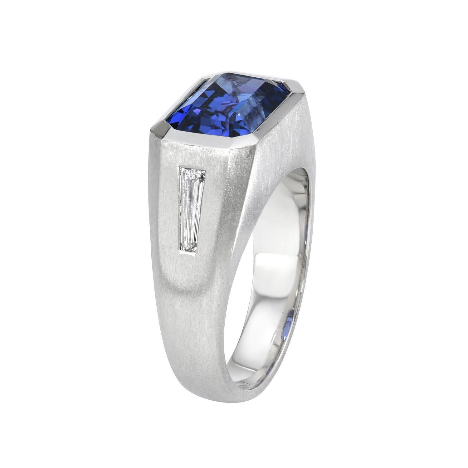 Unisex platinum ring set with a remarkable 6.58 carat Tanzanite emerald-cut and a pair of E/VS1 tapered baguette diamonds weighing a total of 0.44 carats. Matte  brushed finish.
Ring size 10.5. Resizing is complementary upon request.
Crafted by