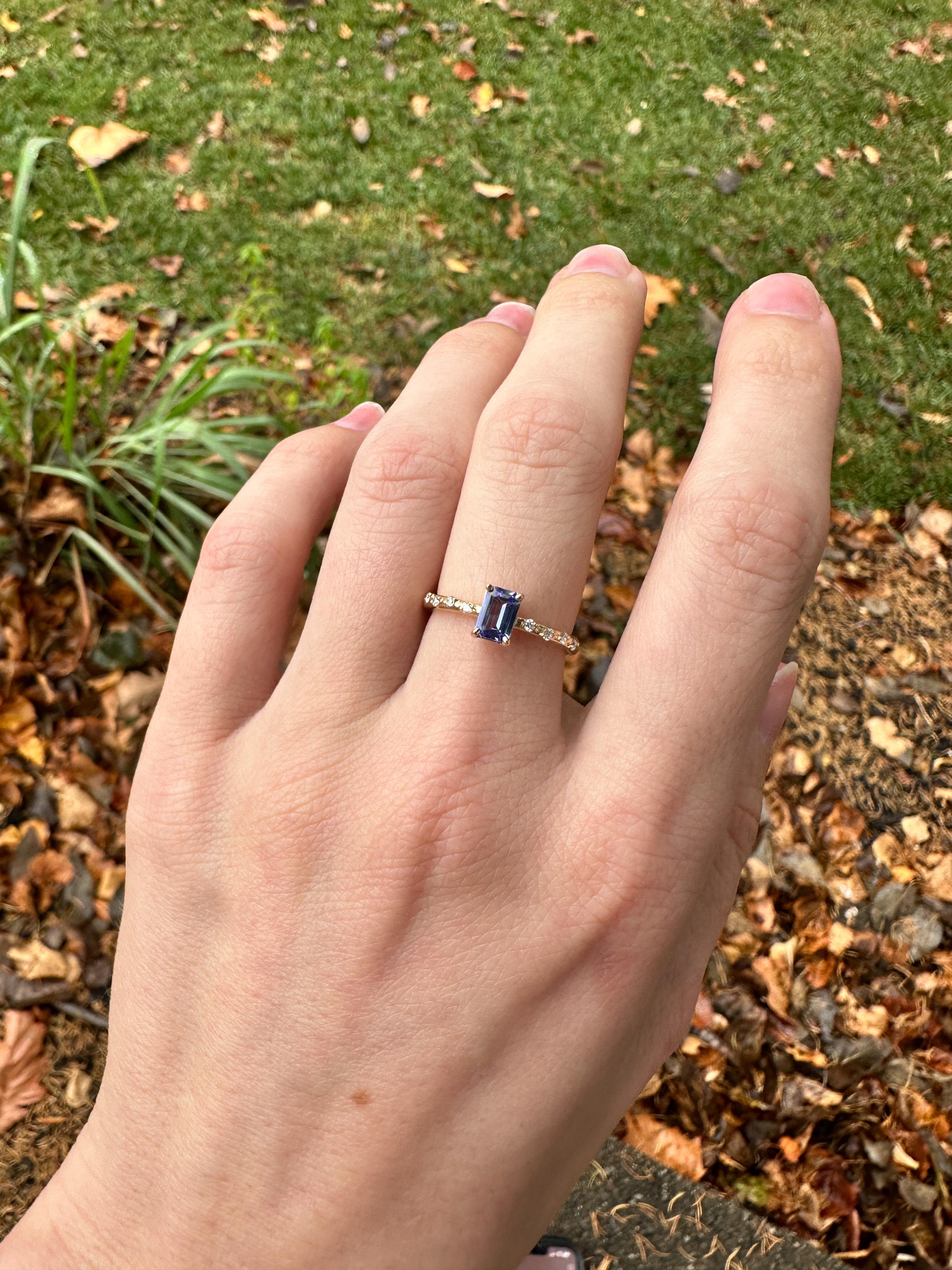 Elevate your style with this 0.6ct Tanzania Ring in solid 14K yellow gold. Featuring a stunning emerald cut tanzanite stone, accented with sparkling earth mined diamonds, this minimalist ring will make a bold statement. Enjoy the potential benefits