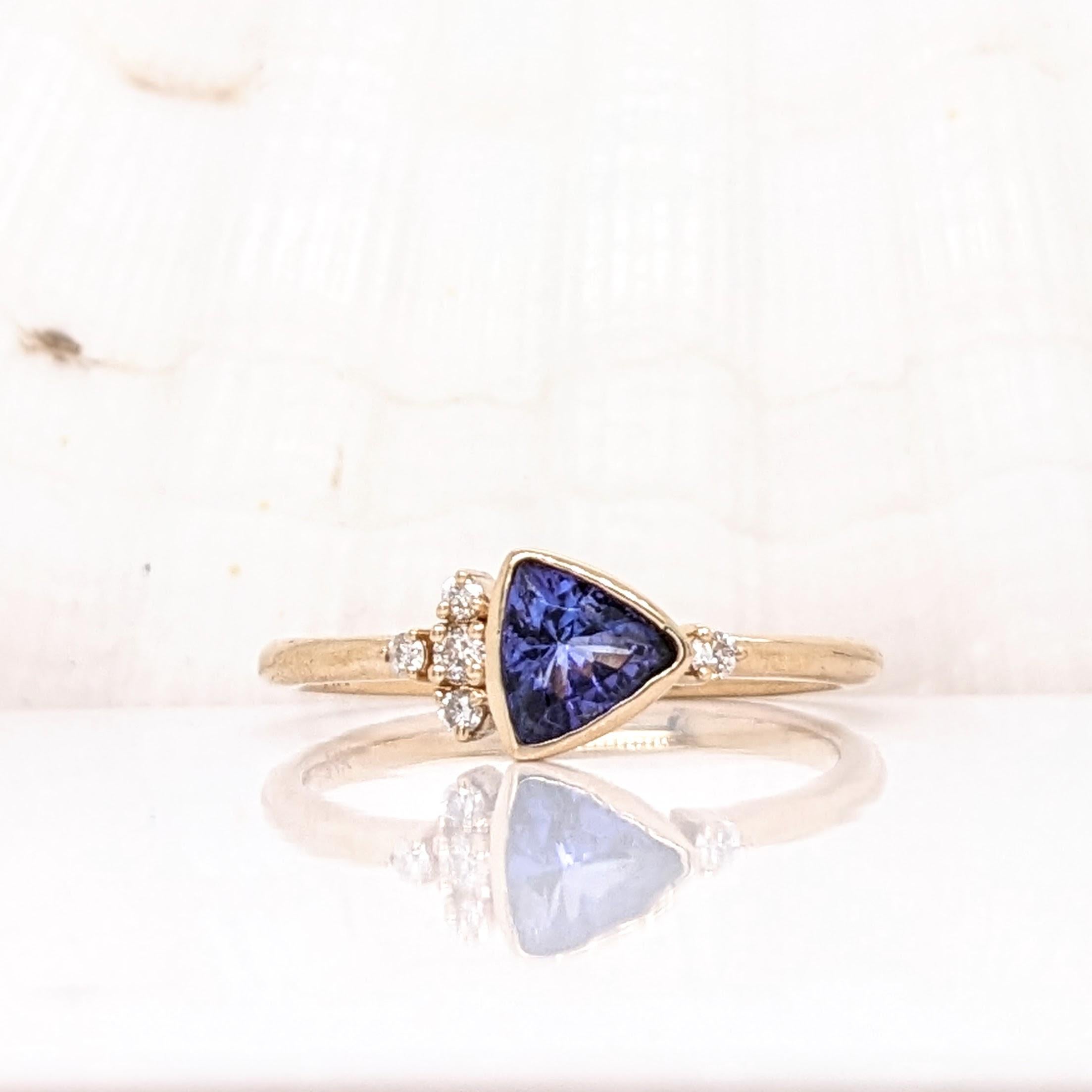 This beautiful ring features a stunning bezel set trillion cut tanzanite in 14K yellow gold with natural diamond accents. This ring makes for a stunning accessory to any look!

Specifications

Item Type: Ring
Centre Stone: Tanzanite
Treatment: