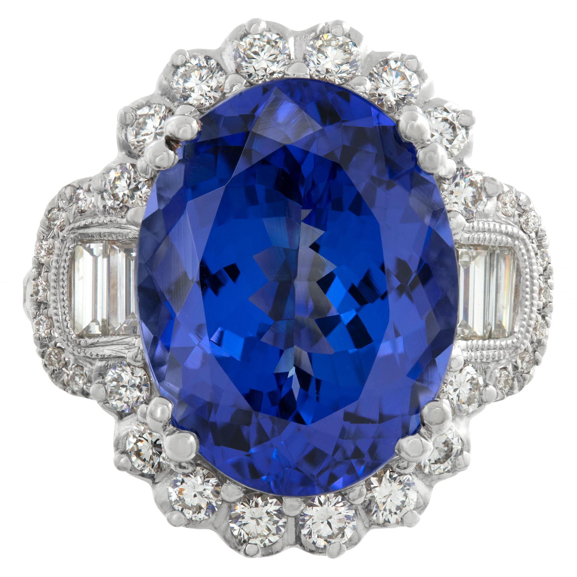 AGL Certified tanzanite and diamond ring in 18k white gold with yellow gold accents. Approximately 1.24 carats in diamonds (H-I color, SI clarity) and 11.05 carat oval tanzanite. Ring size 7.This tanzanite/diamond ring is currently size 7 and some