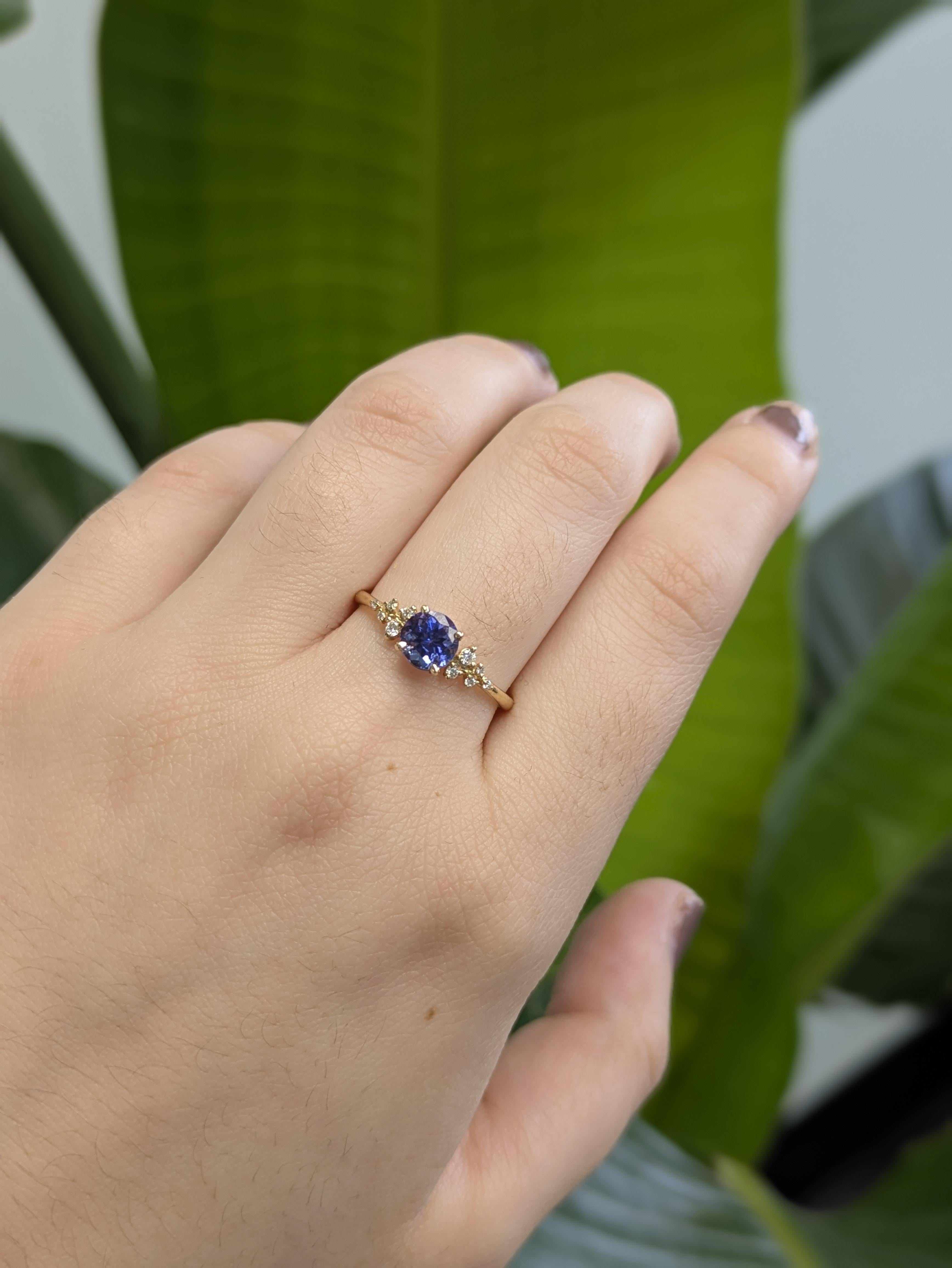 Crafted in warm 14k yellow gold, this dainty ring features a 0.89 carat tanzanite—lovingly heat-treated to bring out its vibrant color. Natural diamonds twinkle on either side, adding just the right touch of shimmer. Chic, feminine, and effortlessly
