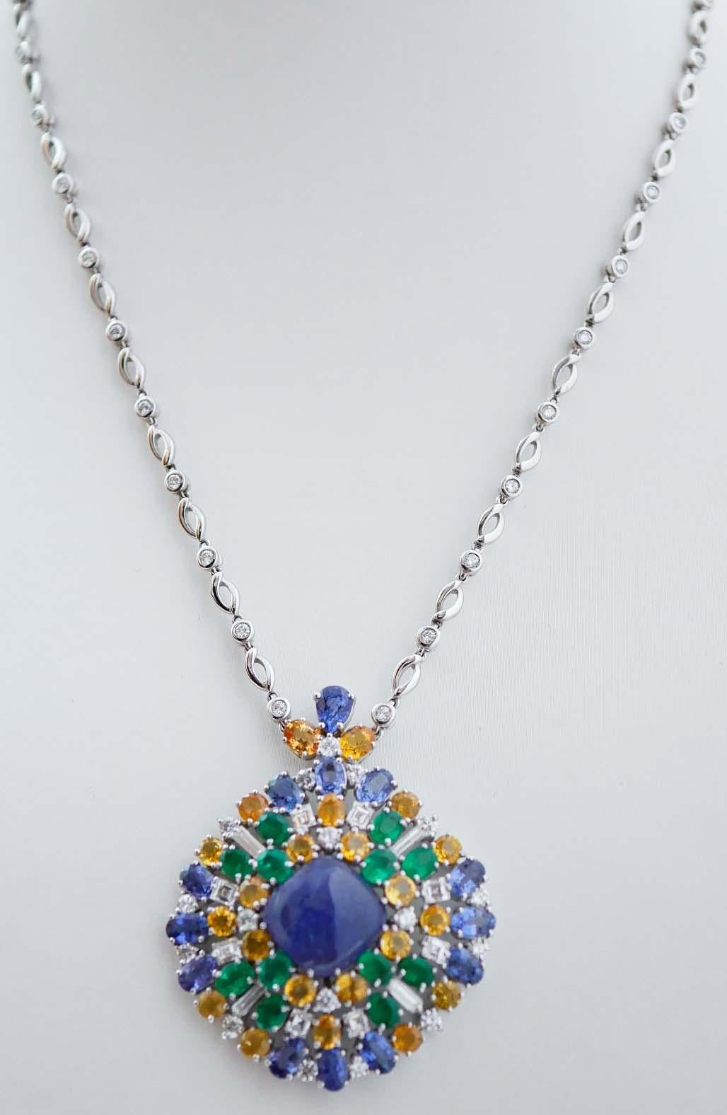 Amazing pendant necklace in 18 kt white gold structure mounted with diamonds along the chain. 
The pendant is mounted with a central tanzanite surrounded by sapphires, emeralds and diamonds.
This necklace was totally handmade by Italian master