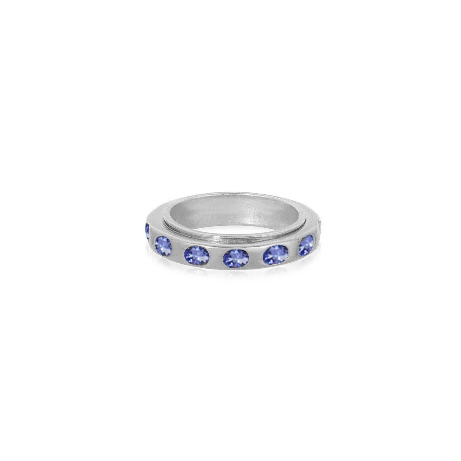 A contemporary band featuring vivid gemstones. This ring features 2.20 Carats of blue Tanzanites set in a Silver band with a stylish high-polish White Gold finish. This jewel features an outer revolving ring set with the alluring blue gems.
