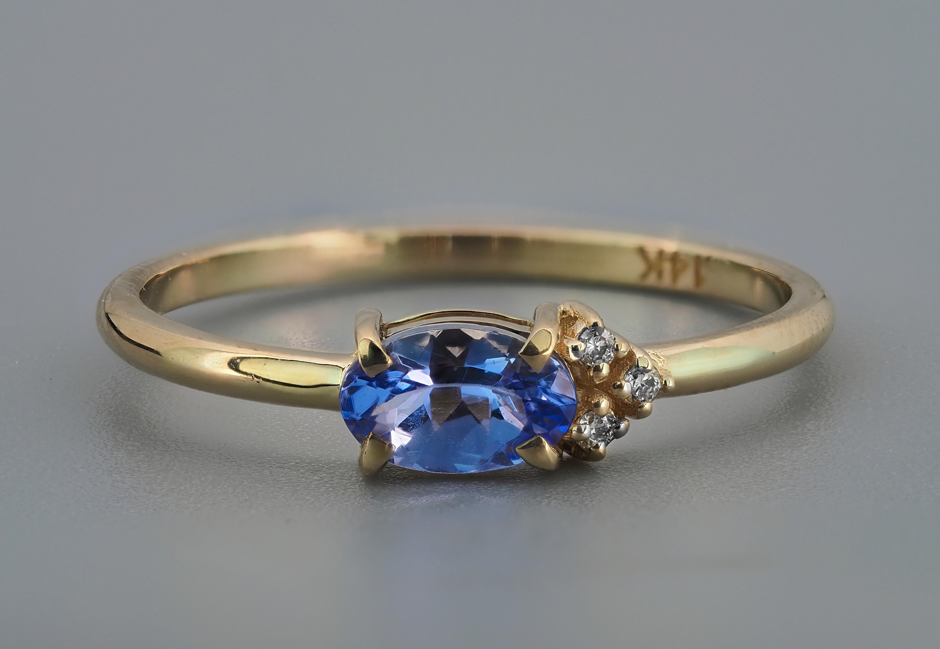 Tanzanite stackable 14k gold ring. 
Oval tanzanite ring. Tanzanite and diamonds ring. Tanzanite delicate ring. Tanzanite casual ring.

Weight: 2 g. depends from size
Metal - 14k  gold.

Central stone: Tanzanite
Cut: oval
Weight: aprox