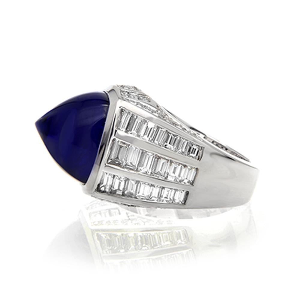 SUGARLOAF TANZANITE AND DIAMOND RING
A dramatic baguette diamond setting for a perfect sugarloaf Tanzanite.

 Item:	# 01649
Setting:	18K W
Color Weight:	17.58 ct. of Tanzanite
Diamond Weight:	4.28 ct. of Diamonds