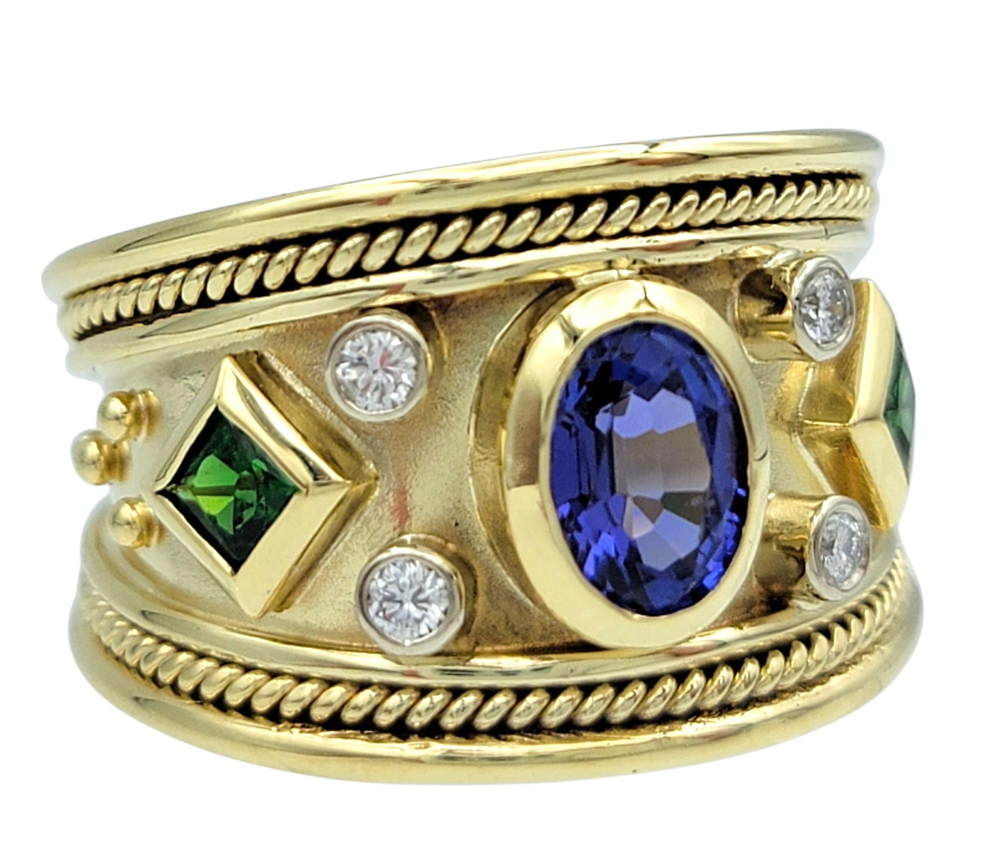 Ring Size: 7

This vibrant and regal ring centers on a richly colored bezel set oval-cut tanzanite with striking cool tones. Flanking the centerpiece are square-cut green tsavorites that bring a bold pop of contrast, enhanced by the shimmer of round