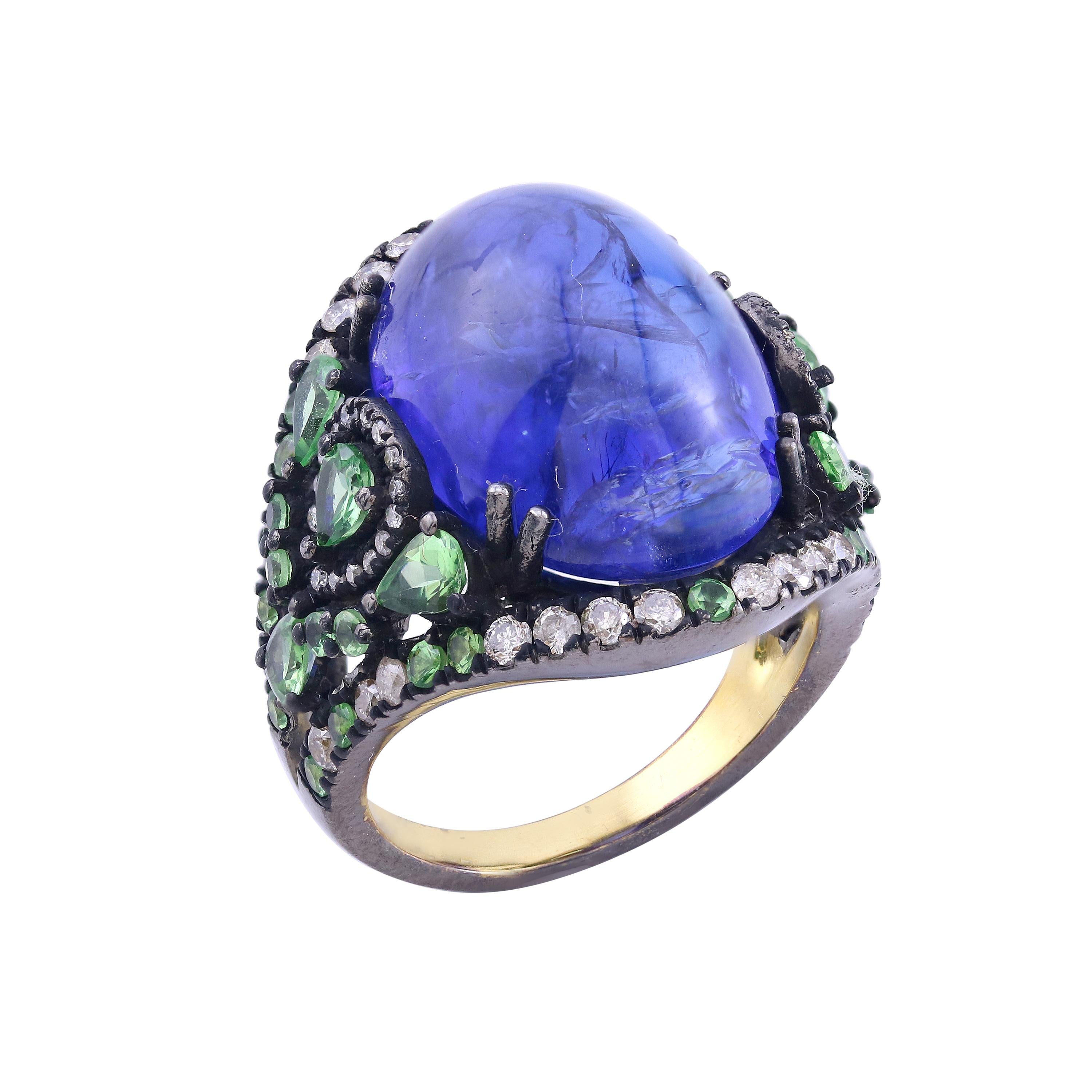 Introducing our exquisite Victorian Split Shank Dome Ring, a true masterpiece that showcases the harmonious combination of a captivating tanzanite, vibrant tsavorites, and dazzling diamonds. Crafted in a luxurious 18K/925 gold setting with black