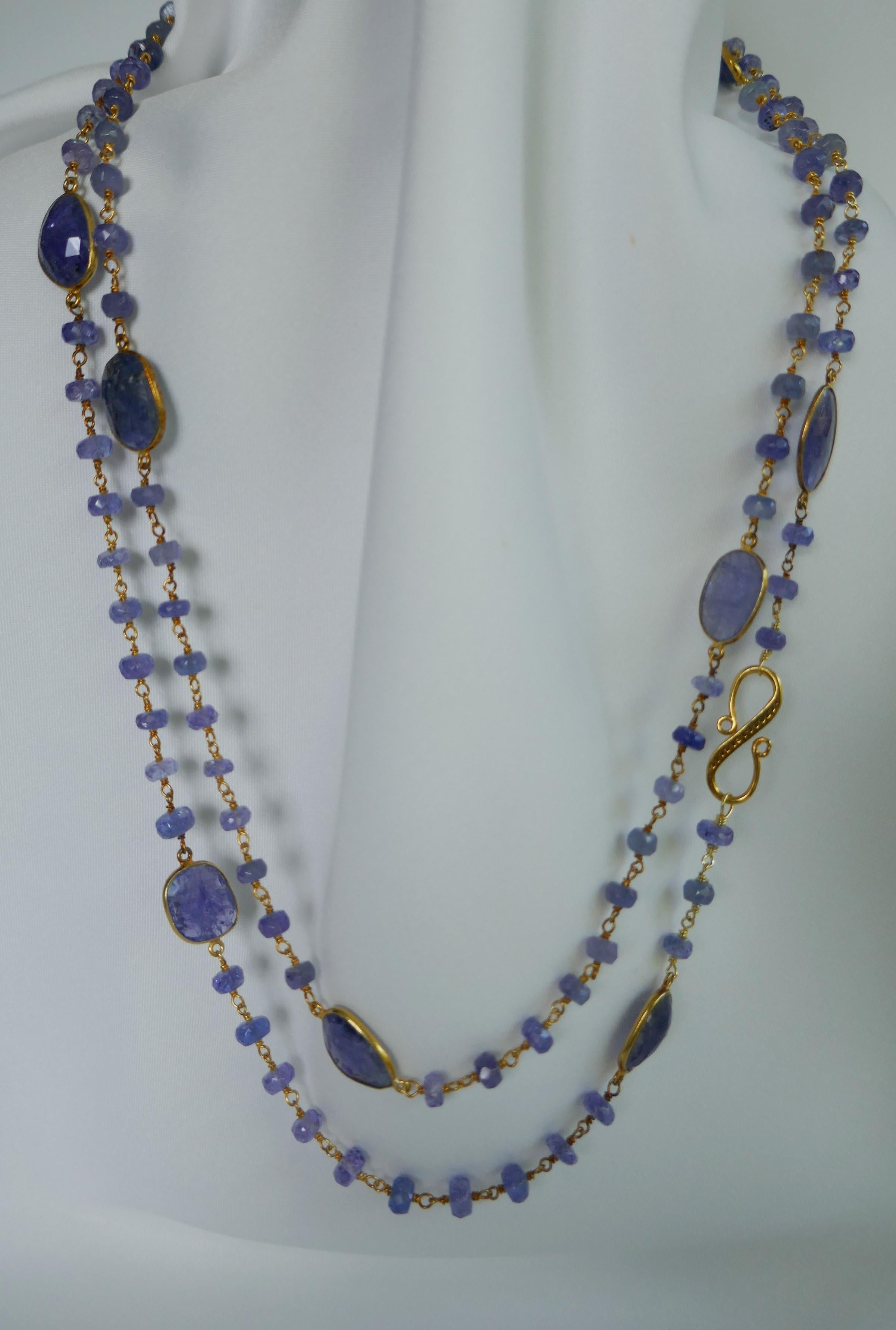 This necklace is two shapes of tanzanite roundels and slices. The roundels are 5-5.5mm and faceted. The tanzanite slices are faceted on one side and smooth on the other. The color of the tanzanite is beautiful. The clasp is an S shaped diamond clasp