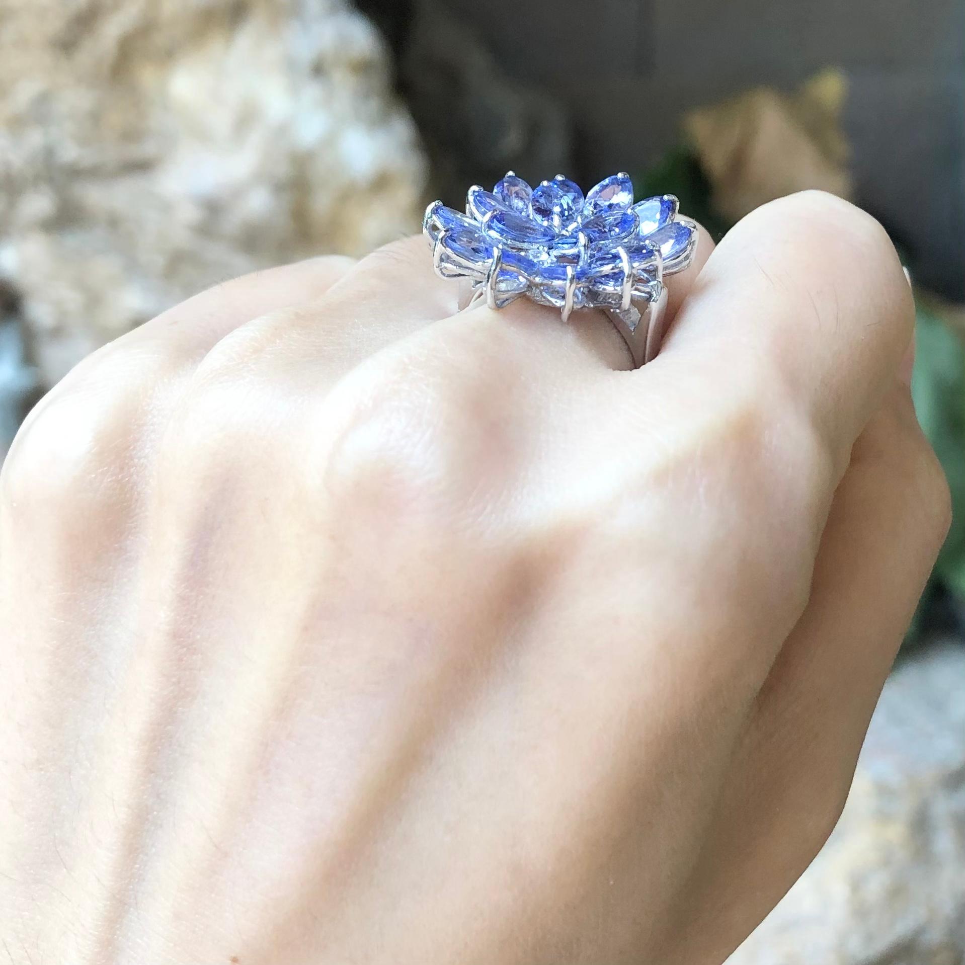 Tanzanite with Cubic Zirconia Ring set in Silver Settings

Width:  2.0 cm 
Length: 2.9 cm
Ring Size: 56
Total Weight: 6.51 grams

*Please note that the silver setting is plated with rhodium to promote shine and help prevent oxidation.  However, with