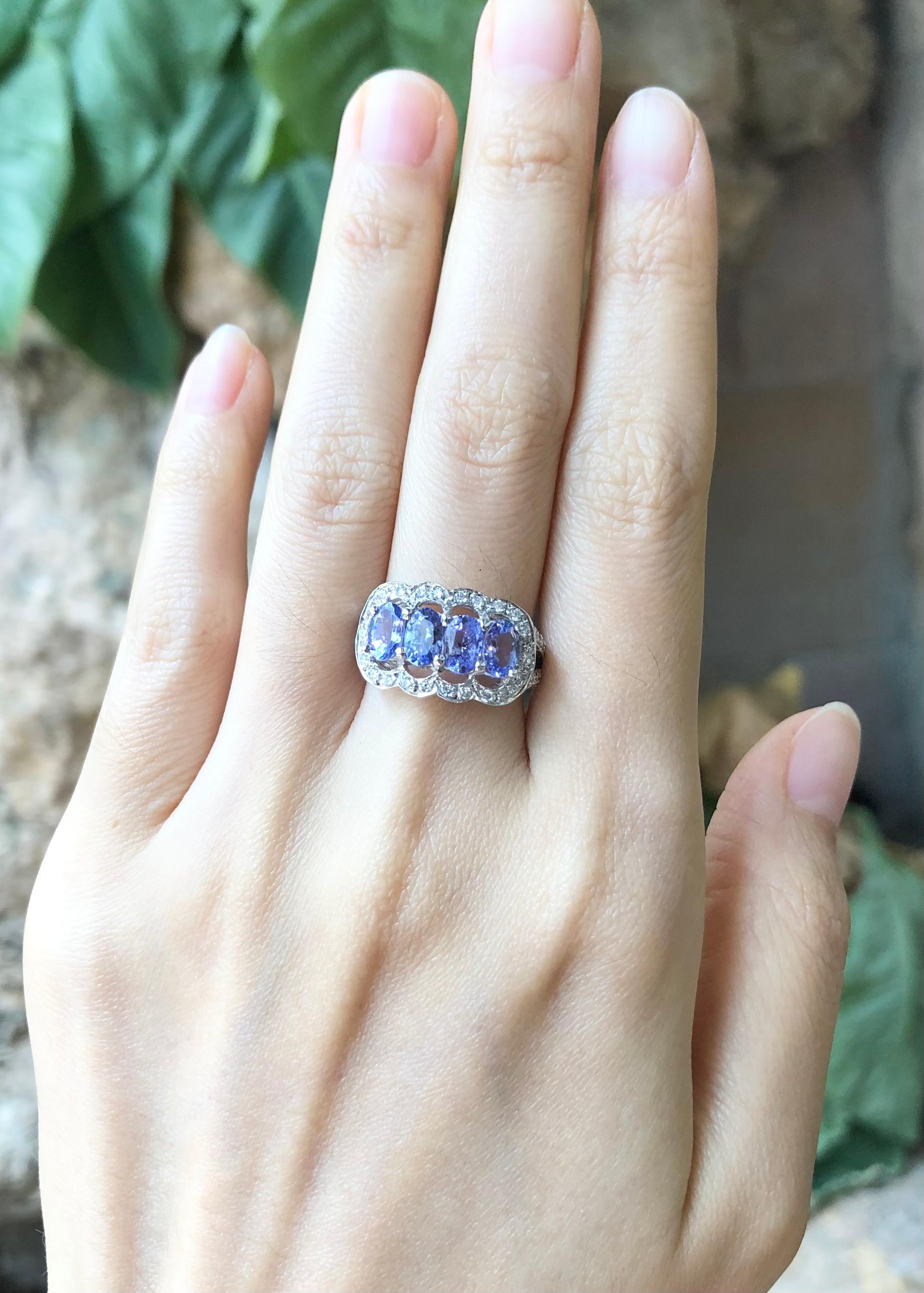 Tanzanite with Cubic Zirconia Ring set in Silver Settings

Width:  1.8 cm 
Length: 1.1 cm
Ring Size: 53
Total Weight: 4.25 grams

*Please note that the silver setting is plated with rhodium to promote shine and help prevent oxidation.  However, with