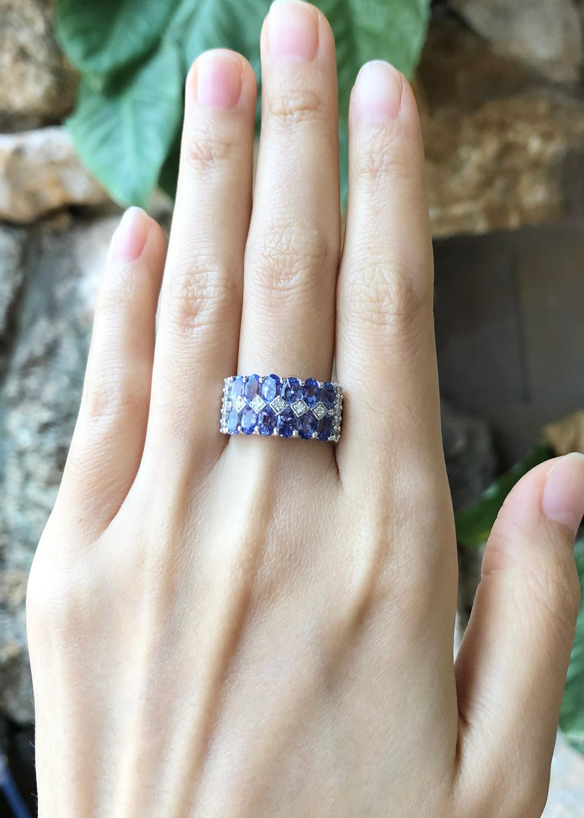 Tanzanite with Cubic Zirconia Ring set in Silver Settings

Width:  2.0 cm 
Length: 1.0 cm
Ring Size: 56
Total Weight: 5.83 grams

*Please note that the silver setting is plated with rhodium to promote shine and help prevent oxidation.  However, with