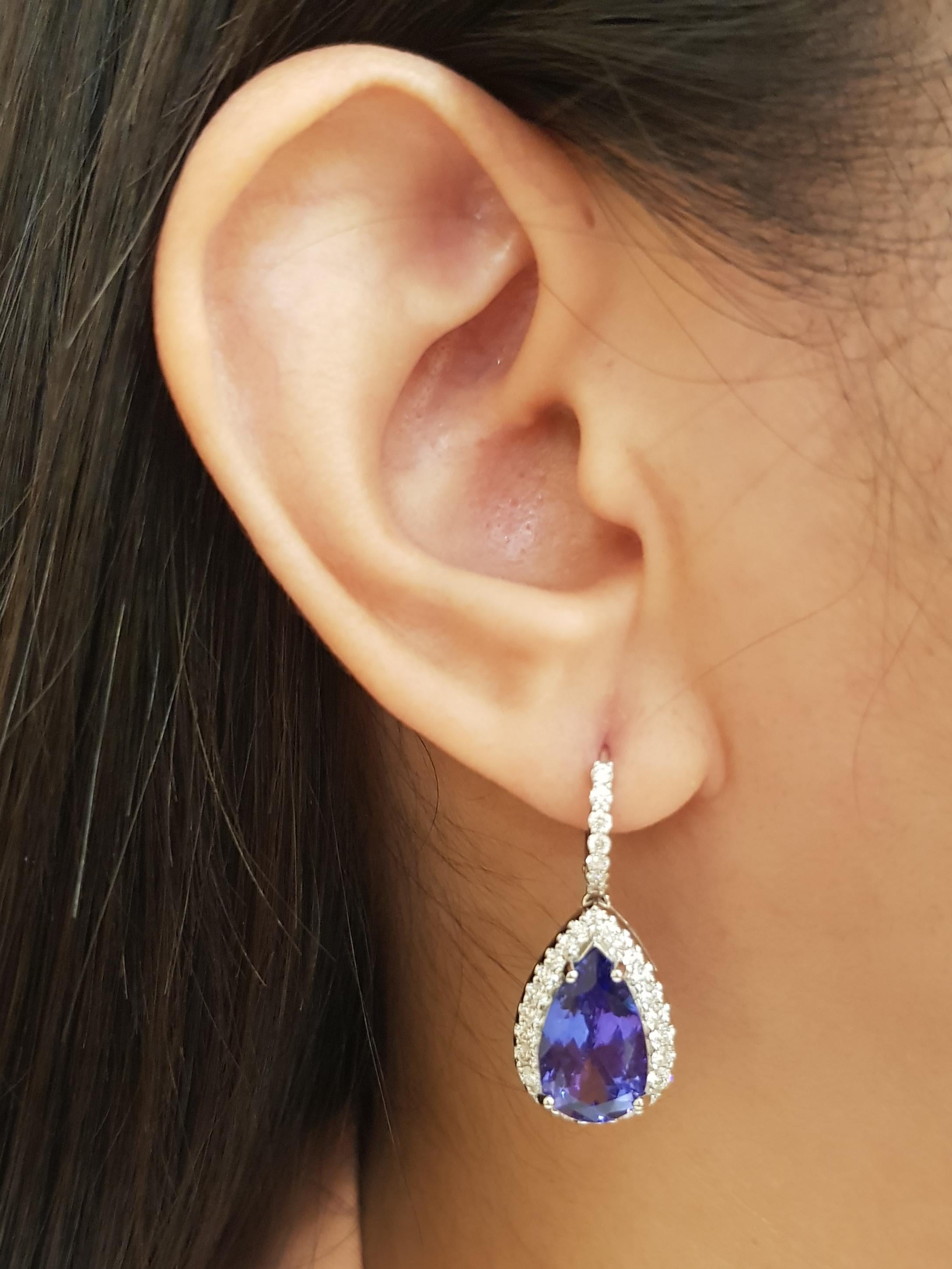Tanzanite 9.36 carats with Diamond 1.26 carats Earrings set in 18K White Gold Settings

Width: 1.3 cm 
Length: 3.0 cm
Total Weight: 9.09 grams

