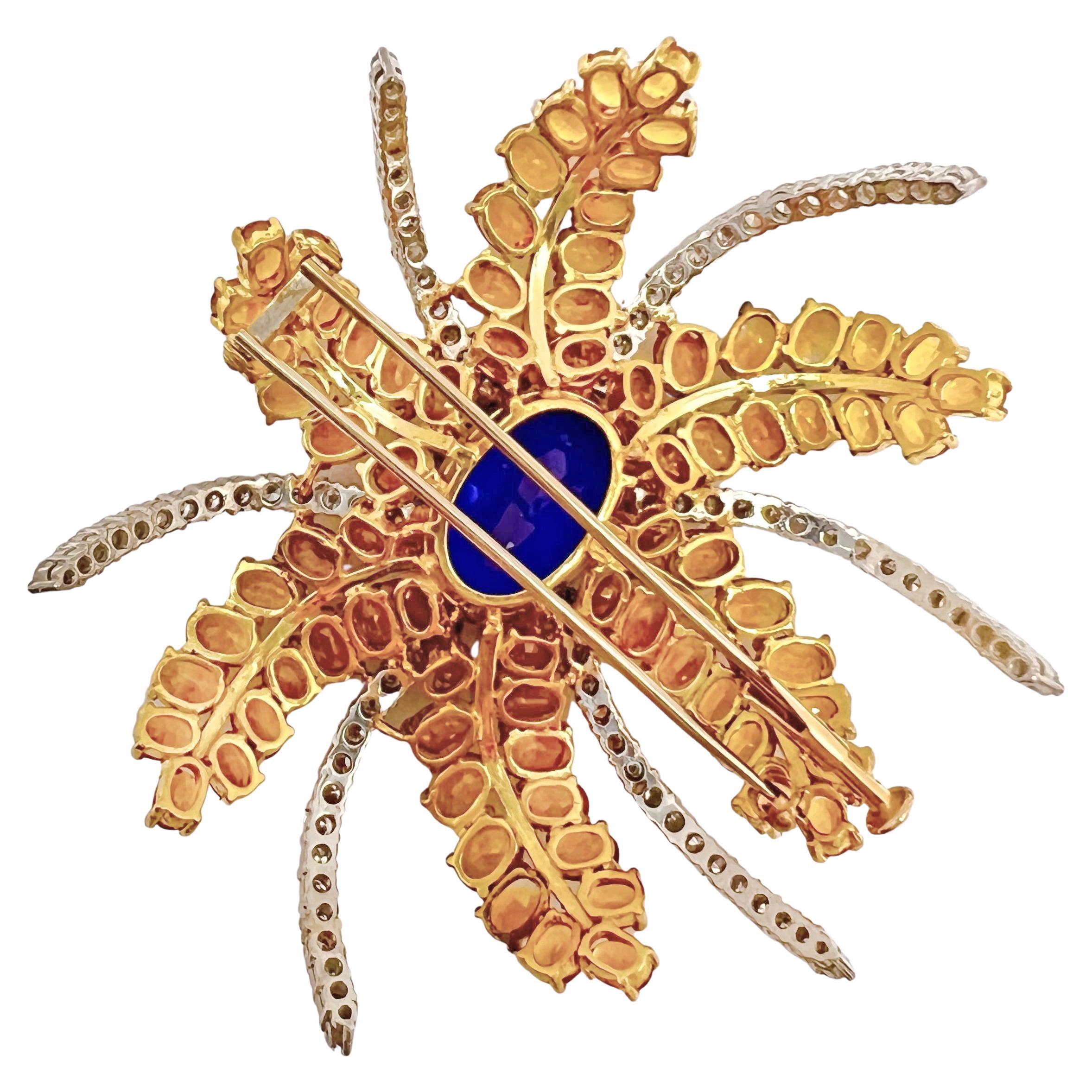 Gem-set stylized fireworks brooch, centering a larger oval-shaped tanzanite with six double-rows of oval-shaped yellow sapphires and five rows of round diamonds radiating outwards. Handmade in 18k yellow and white gold and measuring 2.75