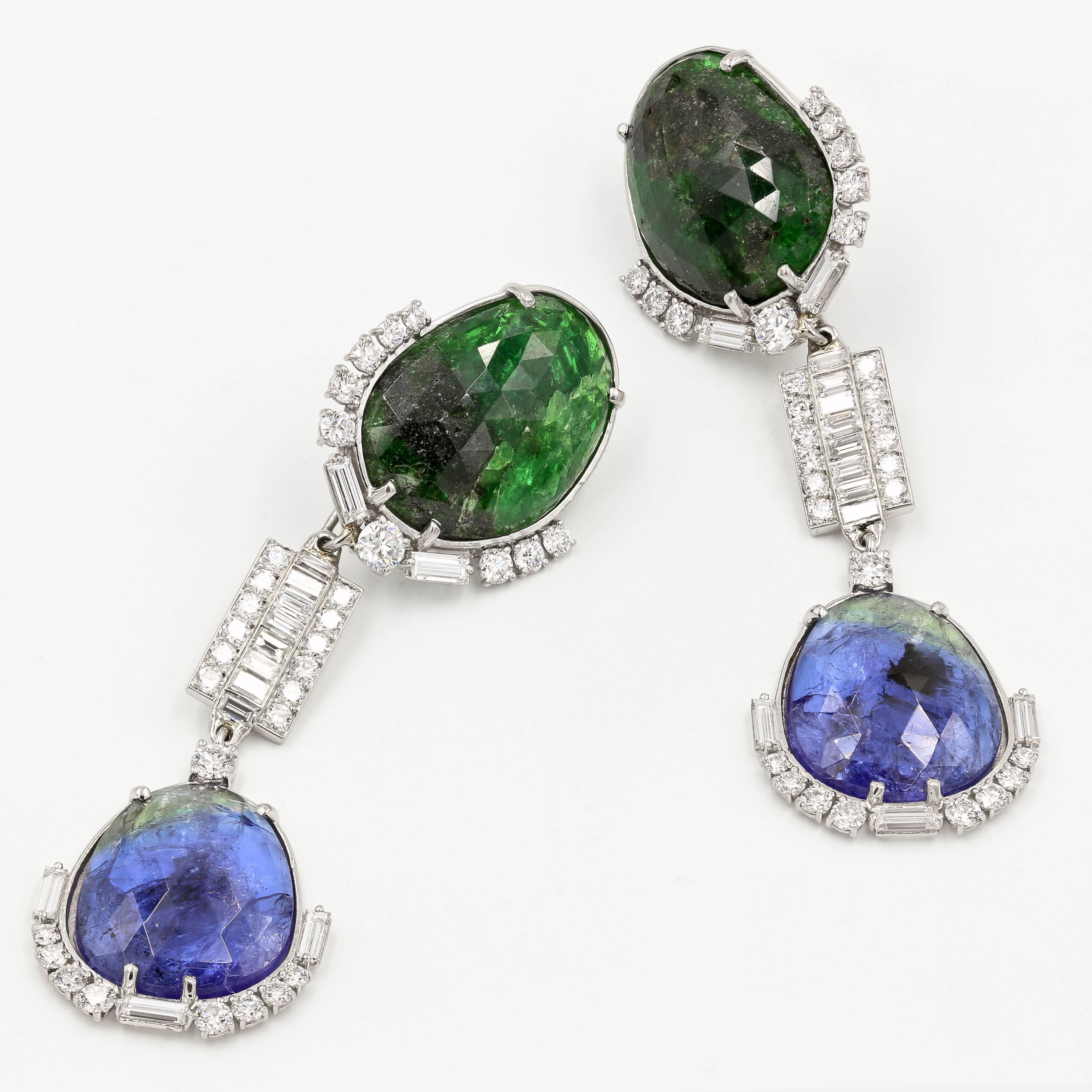 These stunning versatile earrings are truly one-of-a-kind. Set in platinum, they feature 2 tsavorites slices weighing 36.72cts. t.w. at the top and 2 tanzanite slices weighing 26.56cts. t.w. dangling at the bottom. These stones are accented by 36