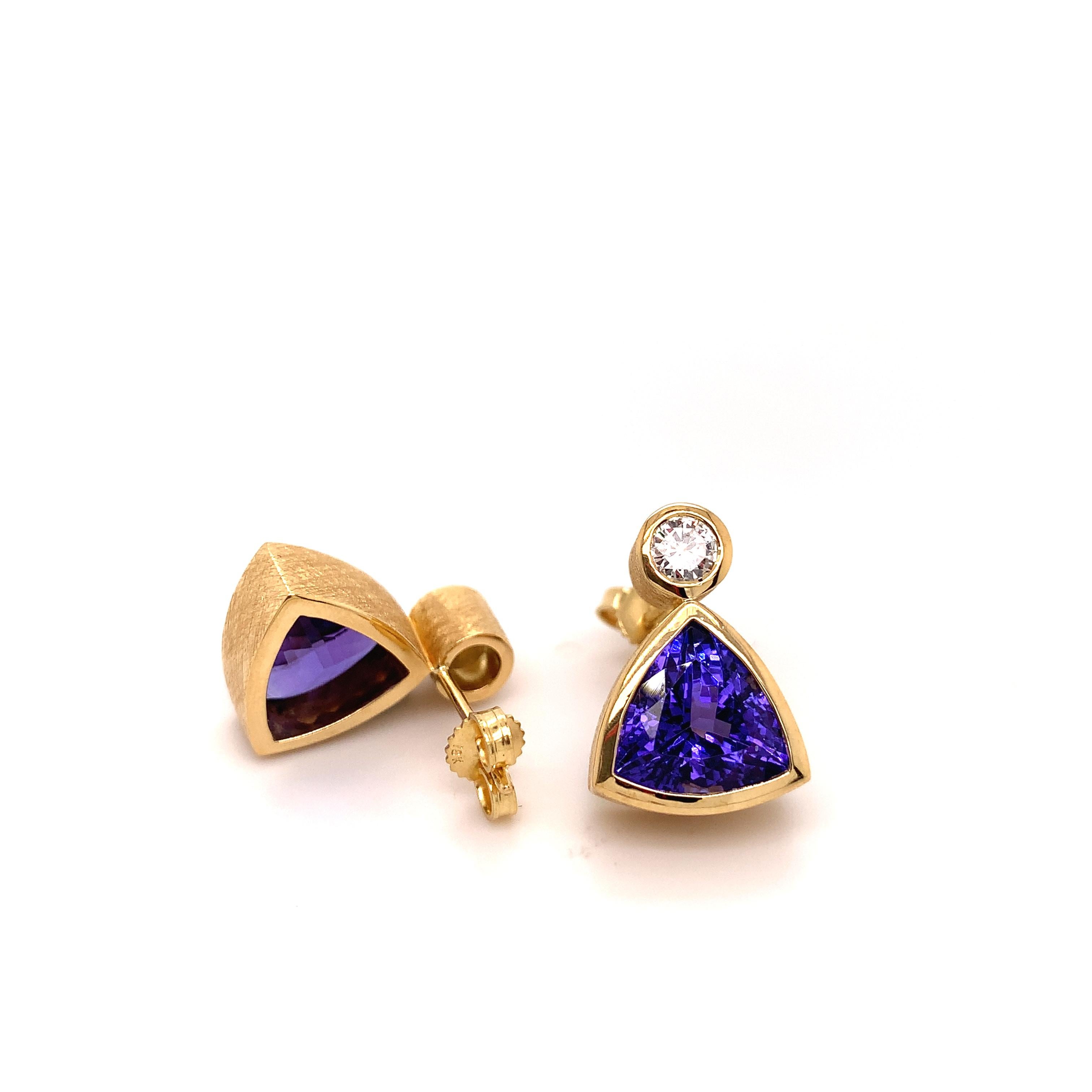This is one of Elke's favorite designs.  She even used this pair on her business card .

These two trillion cut Tanzanites have a total weight of 7.22 carats and are accompanied by two brilliant cut Diamonds. The pair of diamonds are VS grade and G