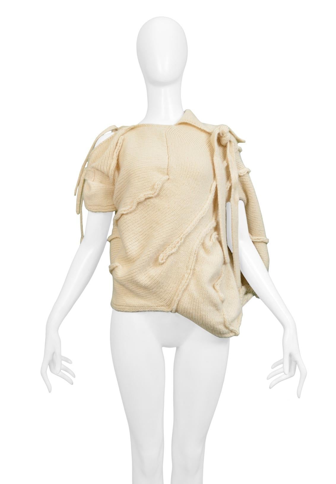 Resurrection Vintage is excited to offer a vintage Tao for Comme des Garcons off-white knit sweater top featuring a cocoon body, tie sleeves and neckline, and asymmetrical seaming.

Tao For Comme Des Garcons
Size: Small/Medium
Fabric: Wool
2008