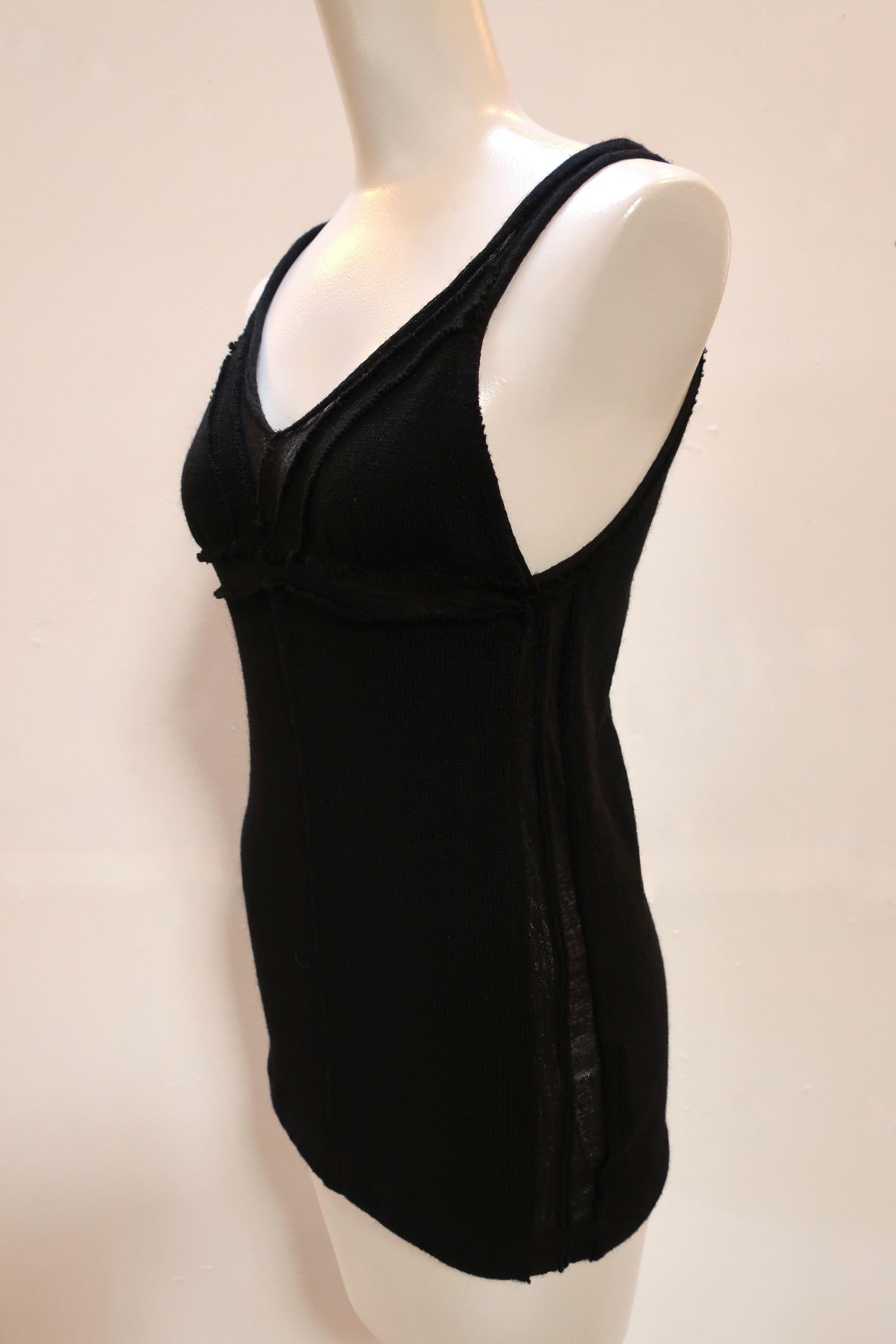 A beautiful knit tank top in black wool comes to you from TAO. This simple tank top is elevated with raw edges and semi-sheer seams. 