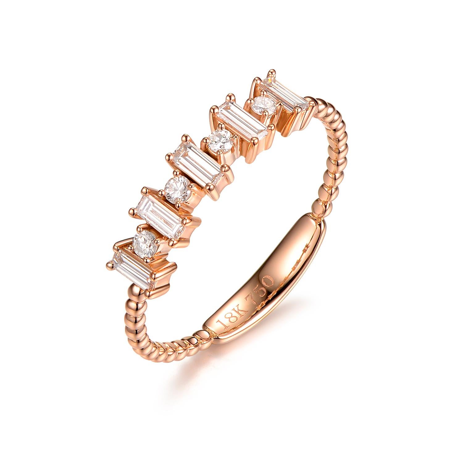 This dainty ring features 0.26 carat of taper diamonds and 0.12 carat of round diamond. Great for everyday use. It's also stack-able with other band rings. Diamonds are set in 18 karat rose gold

US 6.5 
Taper Diamond 0.26 carat
Round Diamond 0.12