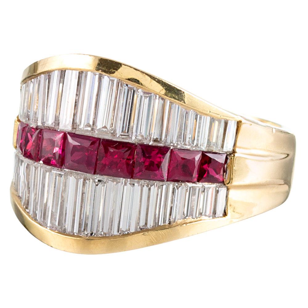 Boasting a smooth and comfortable hand consistent with superior craftsmanship, the ring is rendered in 18 karat yellow gold and set with a single row of tapered French cut rubies (1 carat in total), flanked on both sides by a row of white tapered