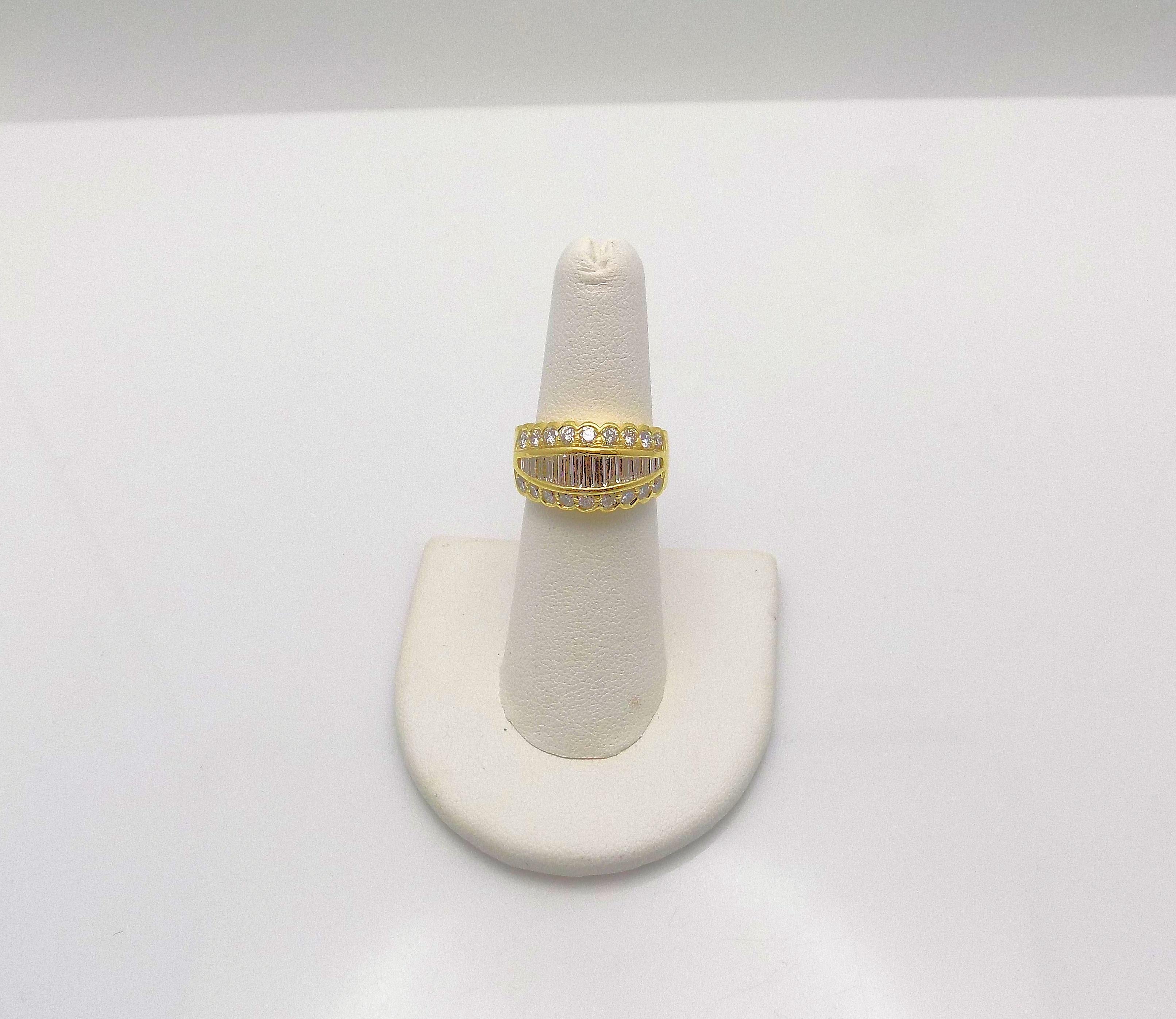 Dazzling 18 Karat Yellow Gold Tapered Band 11.6 X 4 MM featuring 15 Baguettes and 18 Round Brilliant Diamonds 1.25 Carat Total Weight, VS-SI, G-H; Finger Size 6; Signed: JB Star (Jewels By Star) 6.6 DWT or 10.26 Grams.
