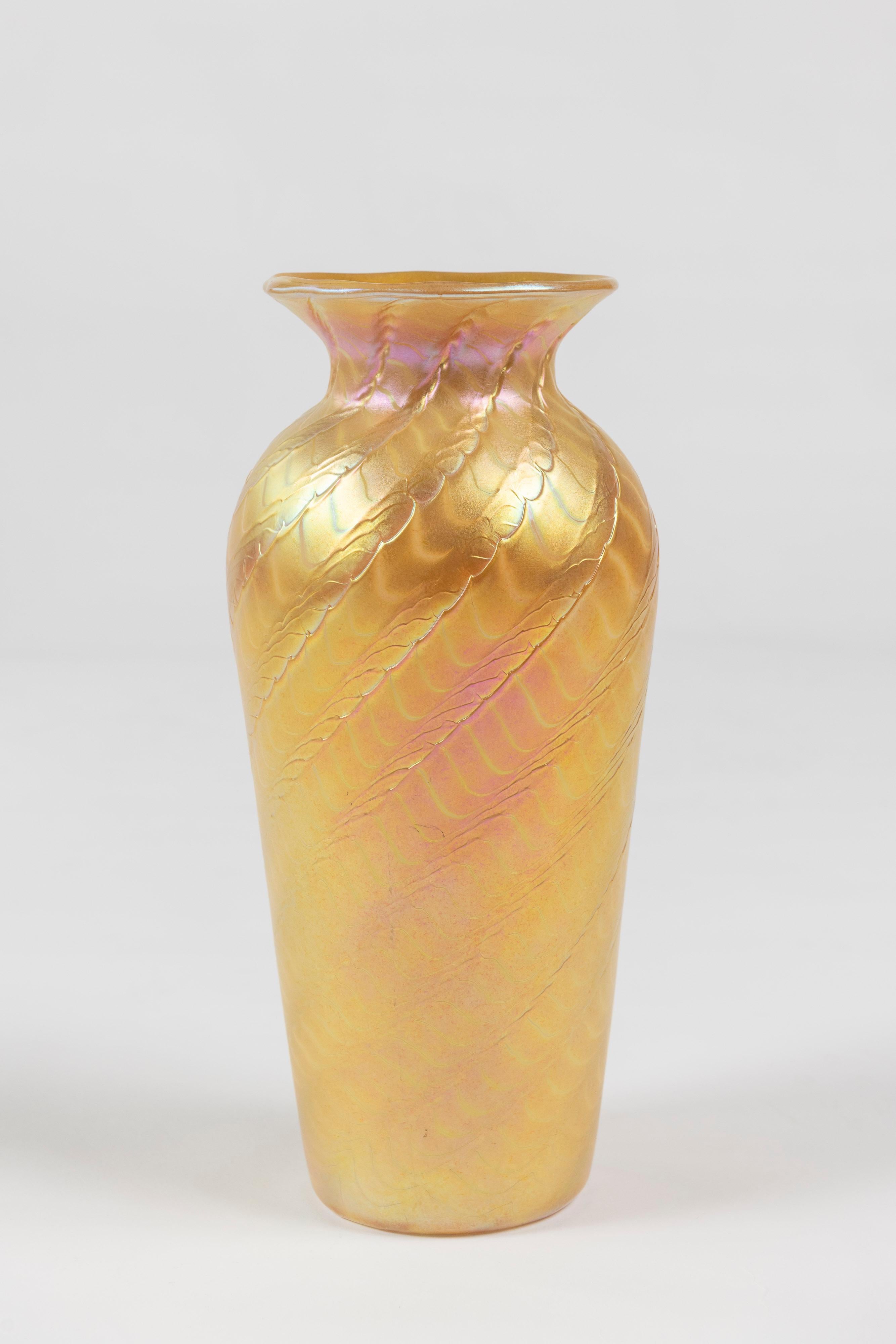 Striking tapered gold aurene art glass vase made by Lundberg Studios, California. Signed in 2000, this vase has a beautiful finish and is in good condition.