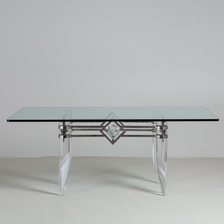 Unusual nickel-plated based desk/dining table with tapered Lucite legs and Lucite cubes held in place by the deco styling of the base, 1970s.

photographed with glass measuring 182.5cm width x 101.5cm depth x 19mm thickness (price does not include