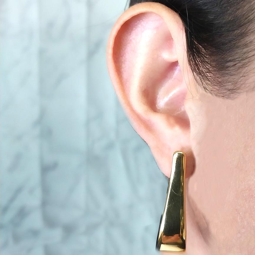 Get a BIG look without a lot of weight! 14 Karat Yellow Gold Electroform Hoop Earrings with Elongated Tapered Design. 1.5 Inches Long. Pierced Post with Hinged Clip Back. Finished Weight is 7.6 Grams.