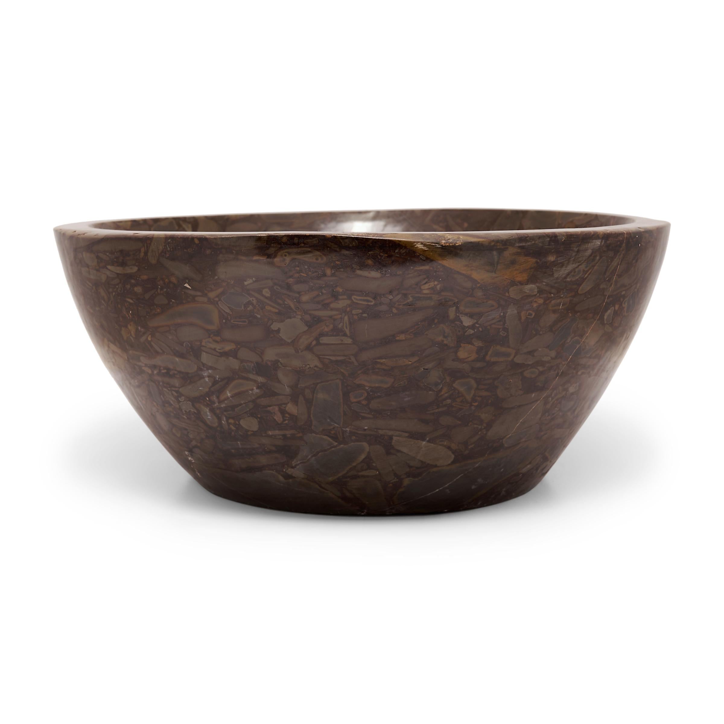 This clean-lined stone basin was hand-carved with a tapered form by artisans in China's Shandong province. Though it looks like a meticulous painting, the mesmerizing pattern of the puddingstone is actually inherent to the stone, a conglomerate