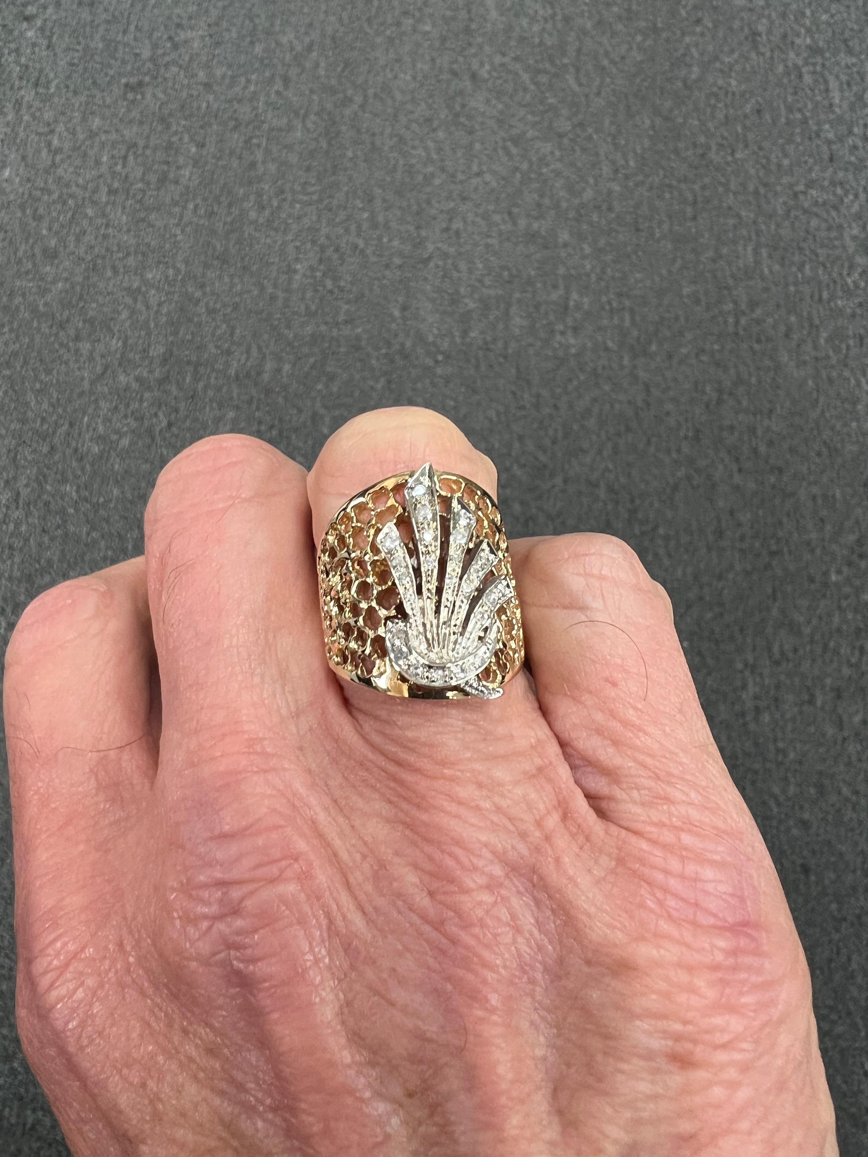 Tapered wide yellow gold diamond band ring, circa 1980s.

The Tapered wide yellow gold diamond band ring from the 1980s  is designed as a textured Swiss cheese feel with open work tapering down to a solid back.  And a diamond spray placard on the