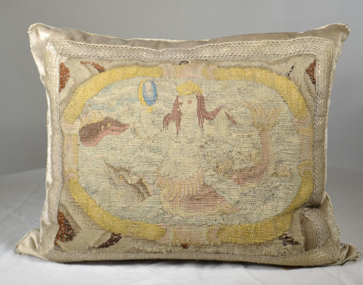 17th century tapestry fragment depicting a mermaid framed in a cartouche framed with antique silver metallic galon on pale warm taupe velvet. Hand trimmed with vintage metallic silver cording knotted in the corners. Down filled. Measures: 17 1/2