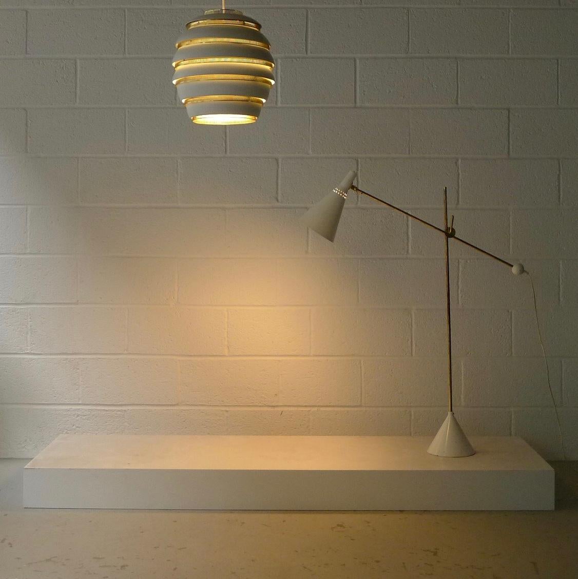Tapio Wirkkala for Idman Oy, Finland, 1958. A model K-10 11 floor lamp, enamelled metal and brass. 

The lamp arm is adjustable in height and angle on the main stem and the shade pivots meaning this lamp has a multitude of possible