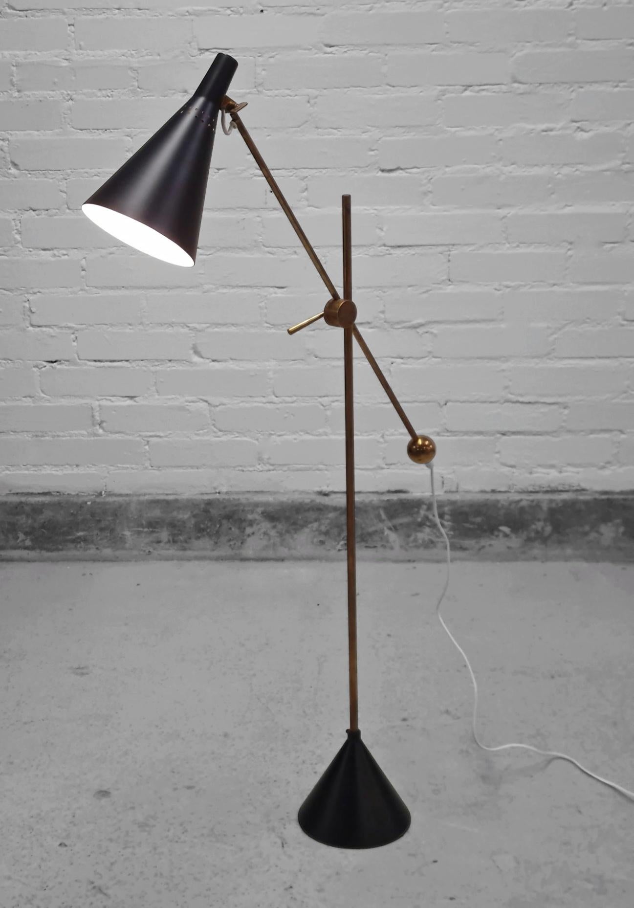 This example of the iconic Tapio Wirkkala floor lamp manufactured and stamped by Idman, retains all original parts and is in beautiful condition. The lamp has been rewired, brass parts polished, and metal parts professionally repainted with the same