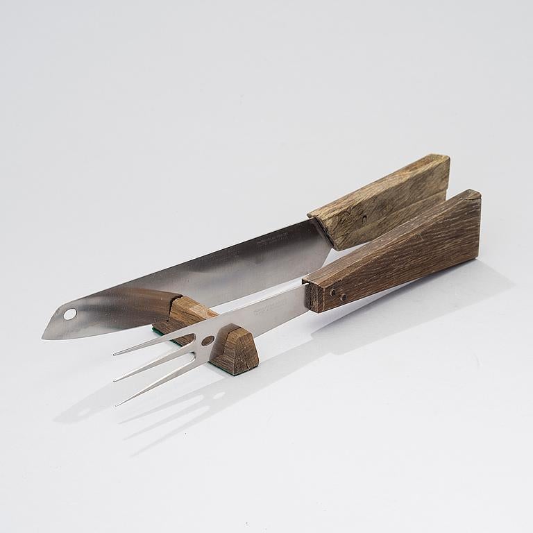 A carving set in brushed steel having a stained oak handle attached to the blade by wooden pegs. The oak comes from the Swedish ship Riksvasa, that sank in 1623, and was famously exploited by the Nahlin brothers. This is a special edition of the