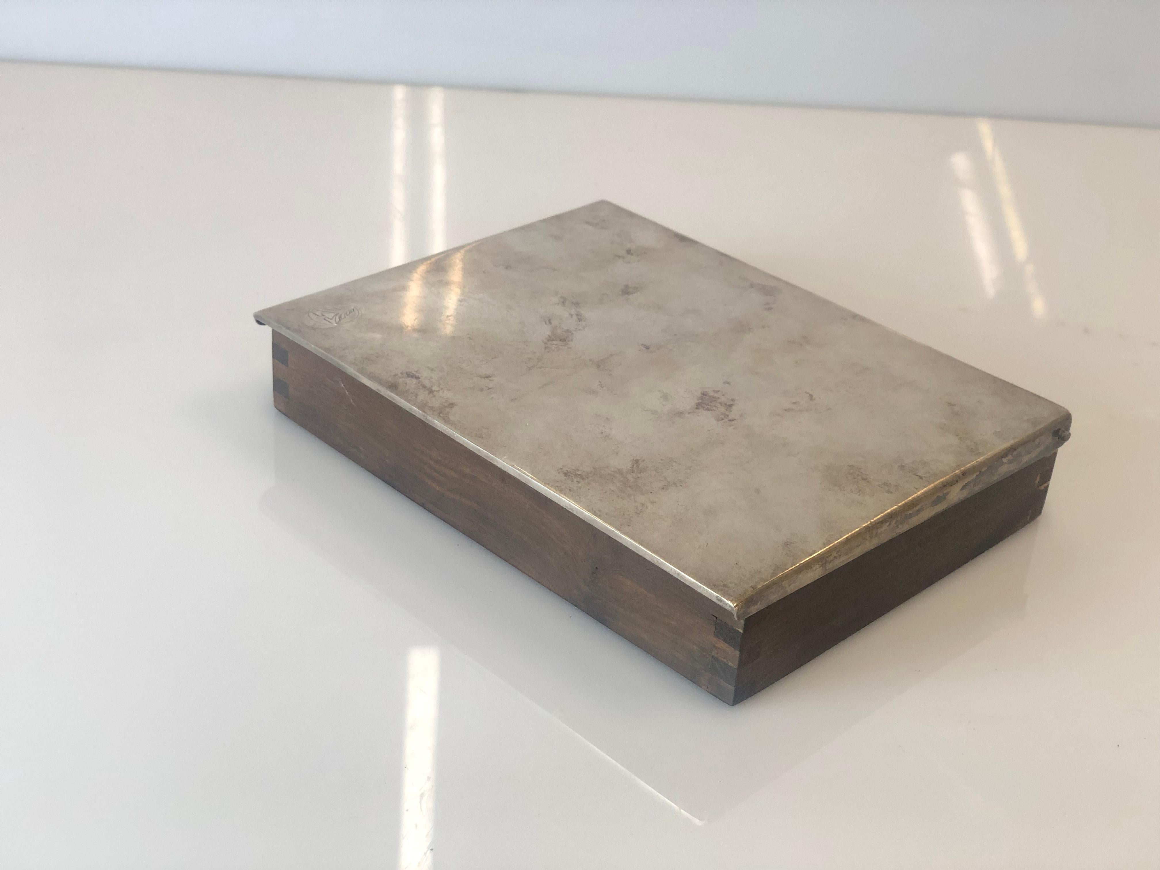 Very rare and unique cigar box in teak and silver. Designed by Tapio Wirkkala. Very sleak and elegant piece for someone who appreciates the 