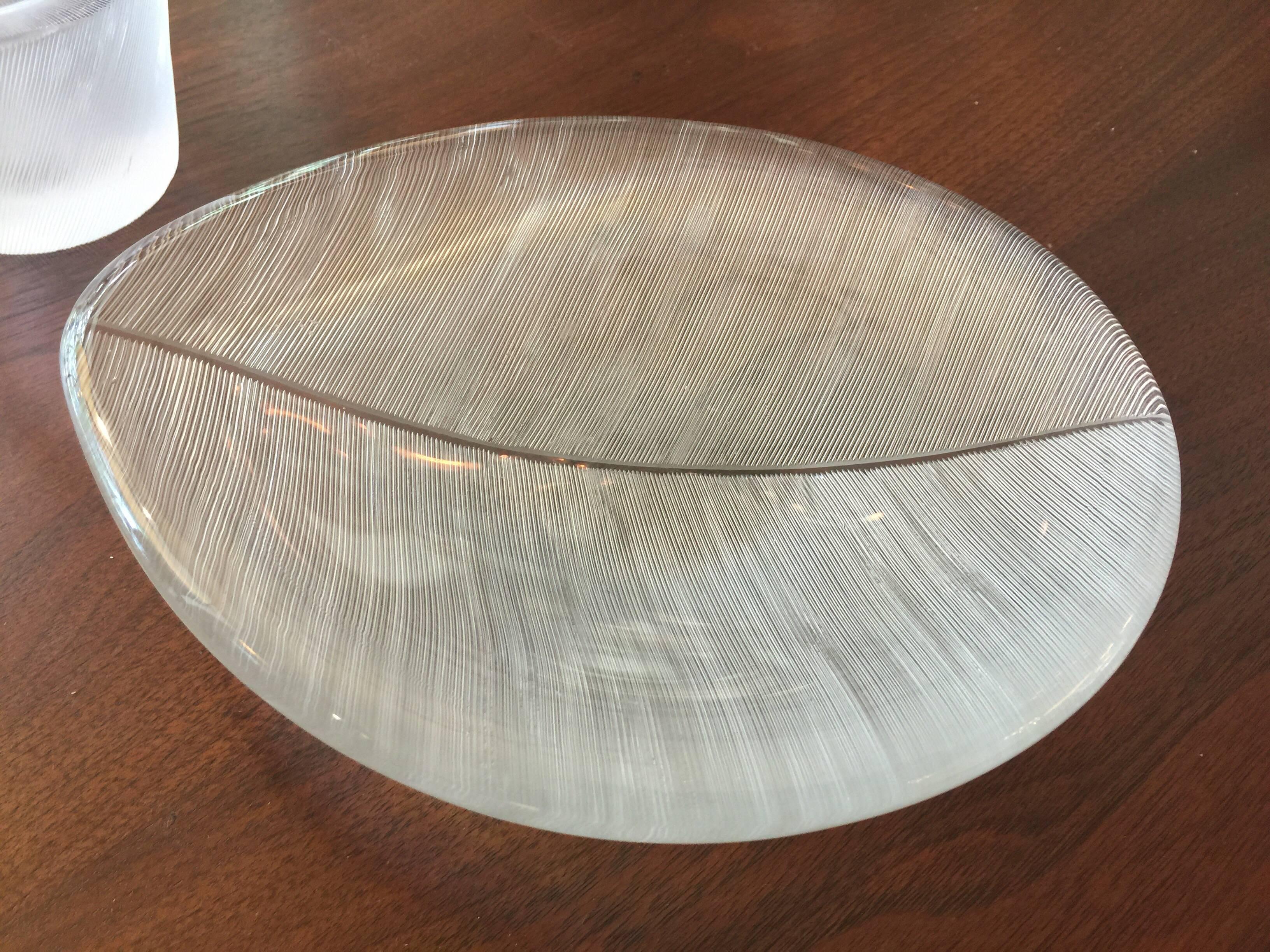 This lovely and signed set of four glass pieces produced by Iittala in line cut engraved forms. Three of the larger bowls have full and distinct signatures along the edges. These exquisite pieces can easily be used in a bar or desk area. 
