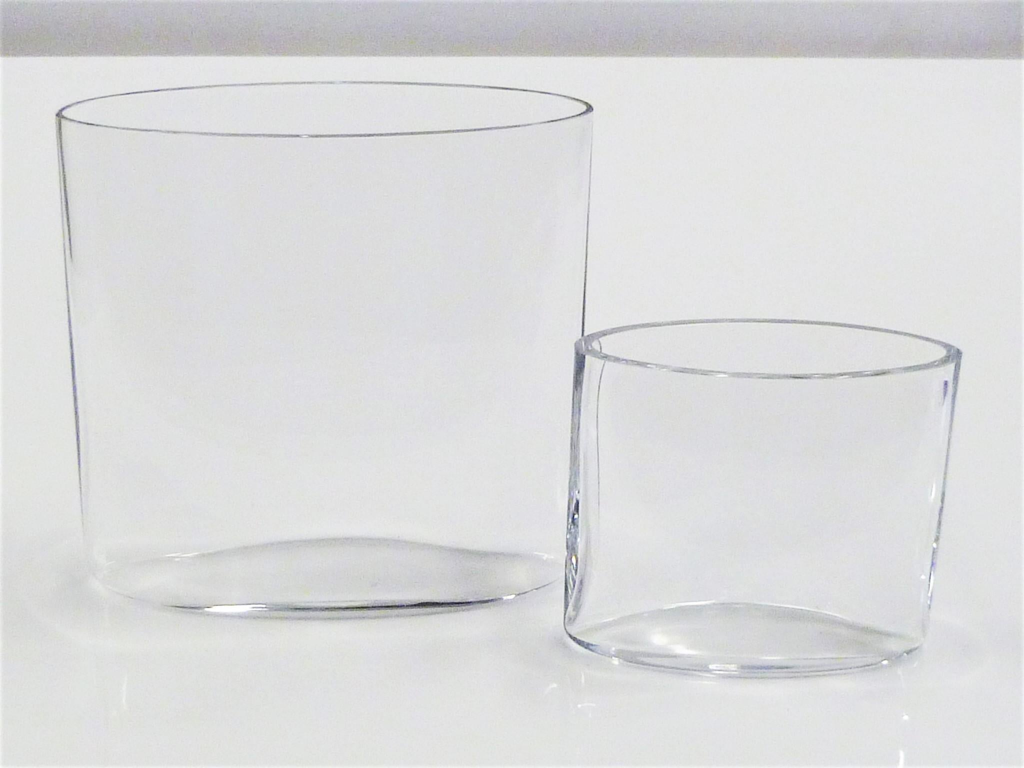 REDUCED FROM $550....Pair of clear glass Ovalis Vases designed by Tapio Wirkkala (1915-1985) for Iittala, Finland in 1958. These hand blown elliptical shaped vases demonstrate the beautiful optical qualities of such a process. This pair is from the