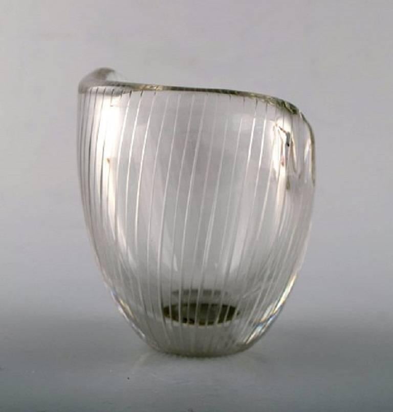 Tapio Wirkkala for Iittala. 
Clear glass vase with engraved decoration in the form of stripes.
Finland, circa 1960.
Signed Tapio Wirkkala, Iittala.
Dimensions 9.5 x 8.5 cm.
In perfect condition.