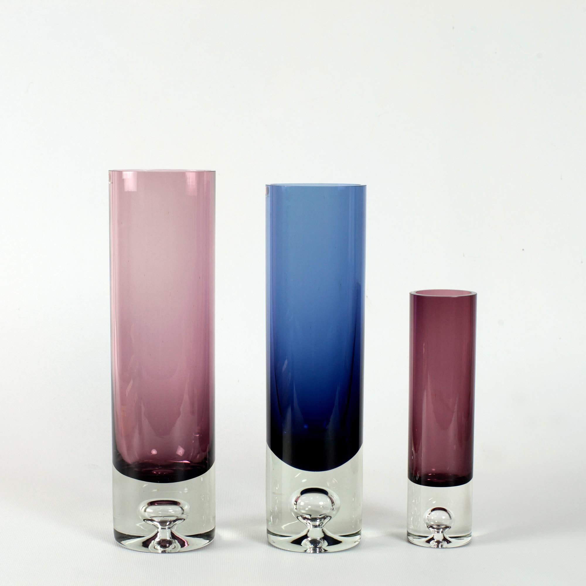 Set of 3 colored glass vases with bubble in base designed by Tapio Wirkkala for Iittala Finland in 1959 and made throughout the 1960s.
Tapio Wirkkala signature and model number engraved under the base.
Dimensions: 8cm/28cm ; 7,5cm/27cm ; 5cm/19cm