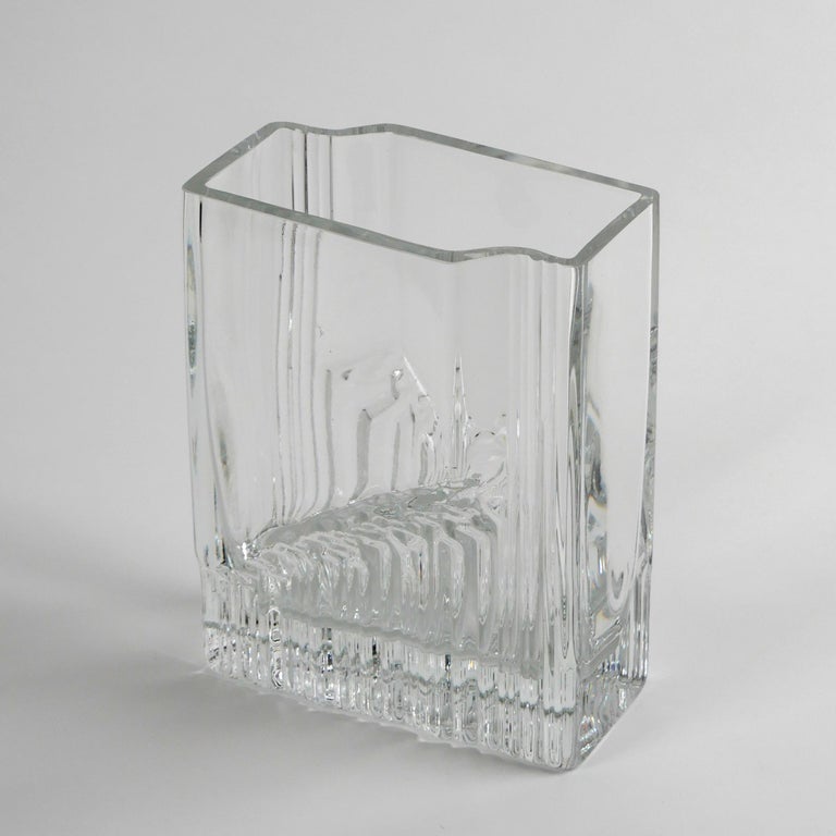 Tapio Wirkkala for Iittala, 1970
‘Sointu’ (Chord) vase

Clear glass
Excellent condition
Engraved signature to underside ‘TW’
This design was in production from 1970 to 1992.
Dimensions approx.: width 14cm, depth 9.5cm height 18cm; weight: