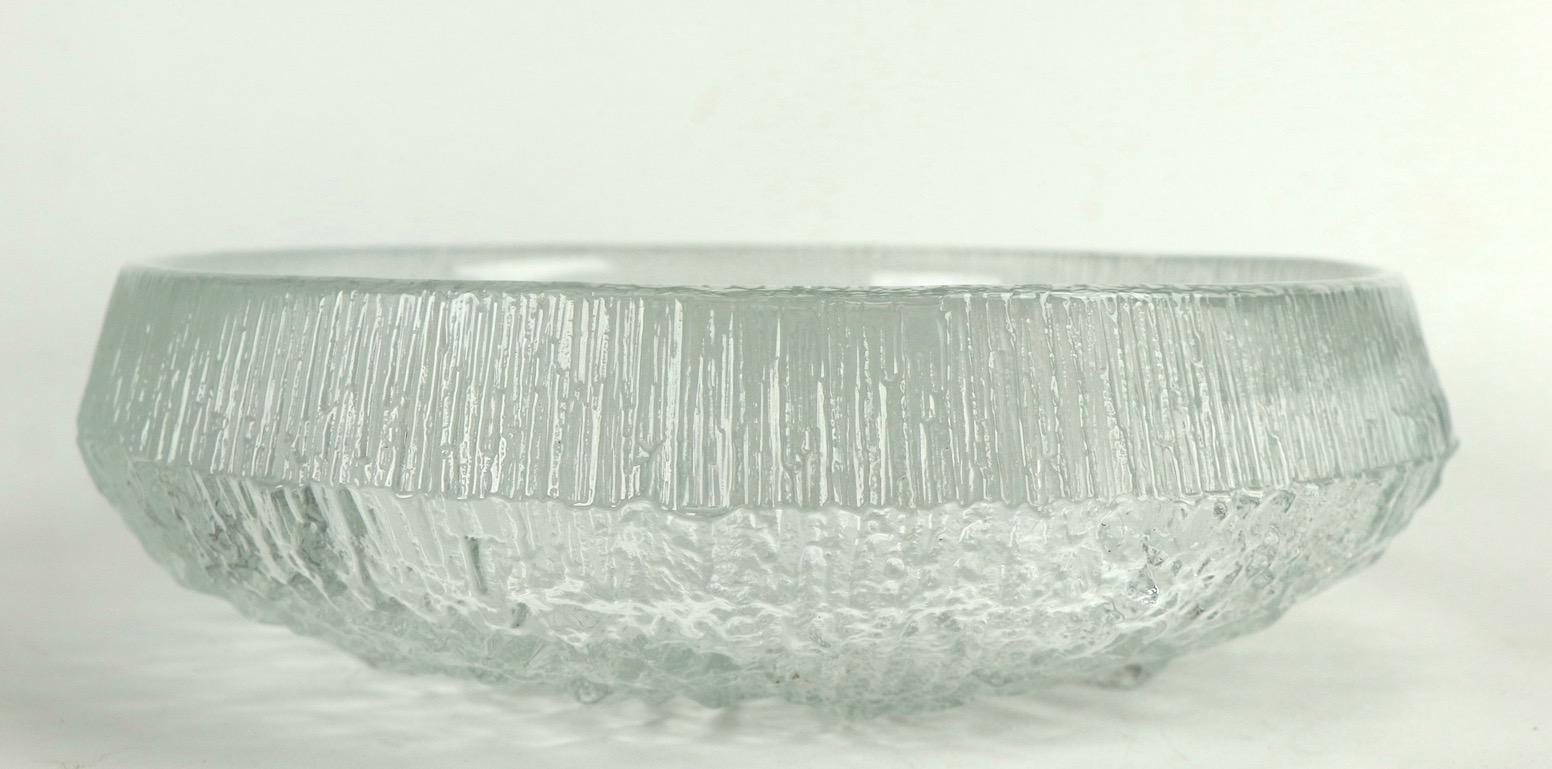 Nice center bowl designed by Tapio Wirkkala for Ittala. Clear glass with textured ice surface. Original clean and undamaged condition, unsigned.
    